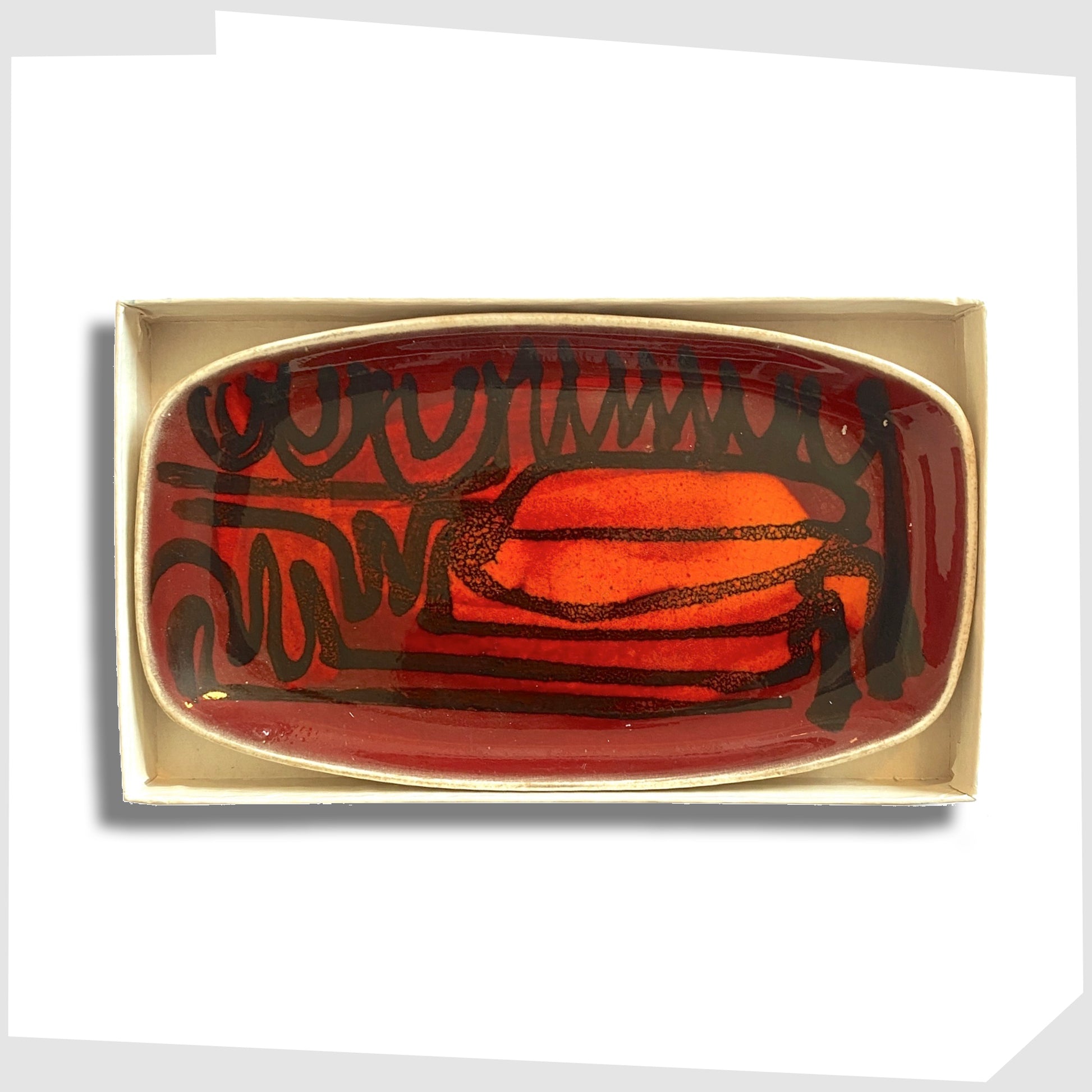 vintage poole pottery delphis pin dish with its original box, glazed in a rich red and orange glaze with black flowing lines