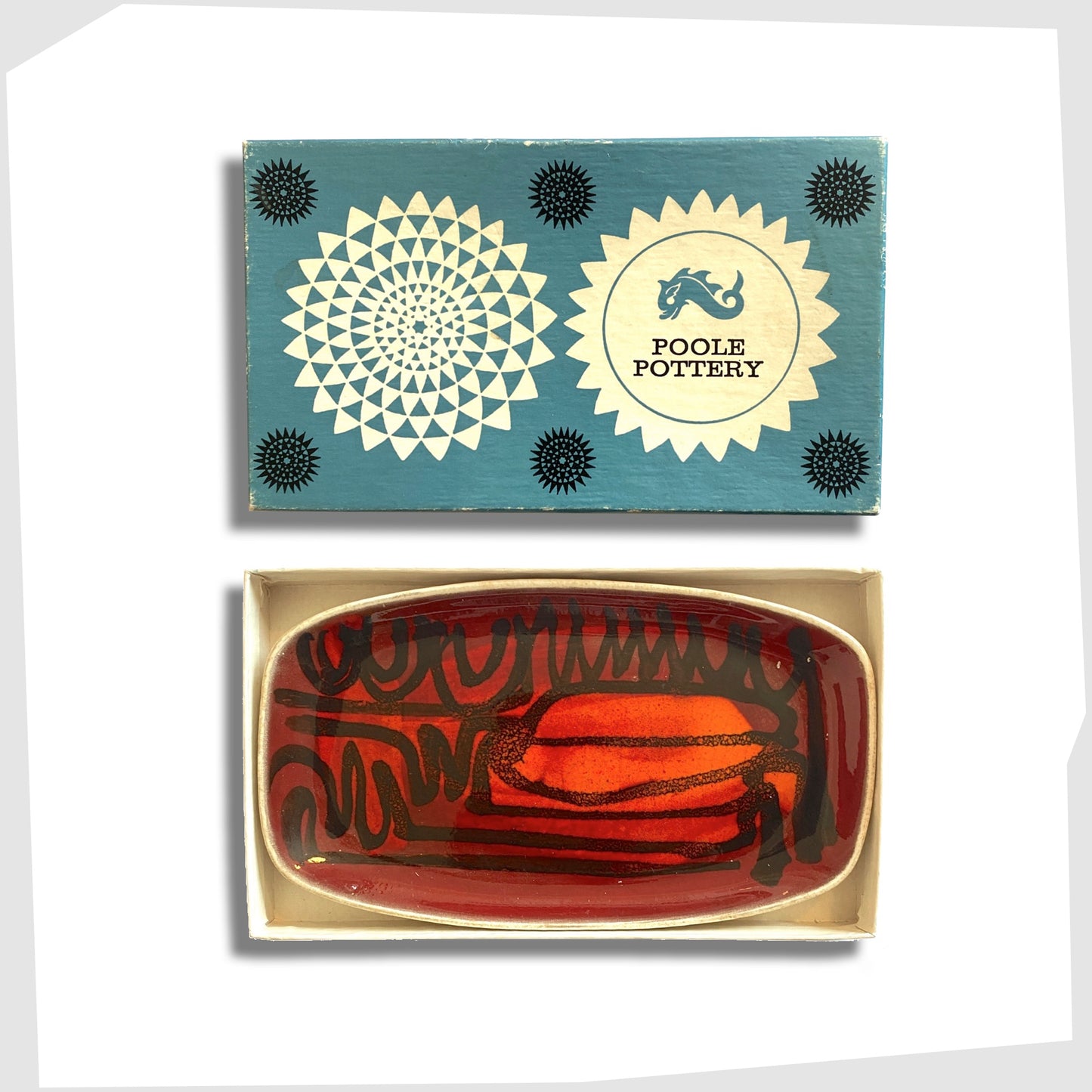 poole pottery delphis pin dish with its original box, glazed in a rich red and orange glaze with black flowing lines