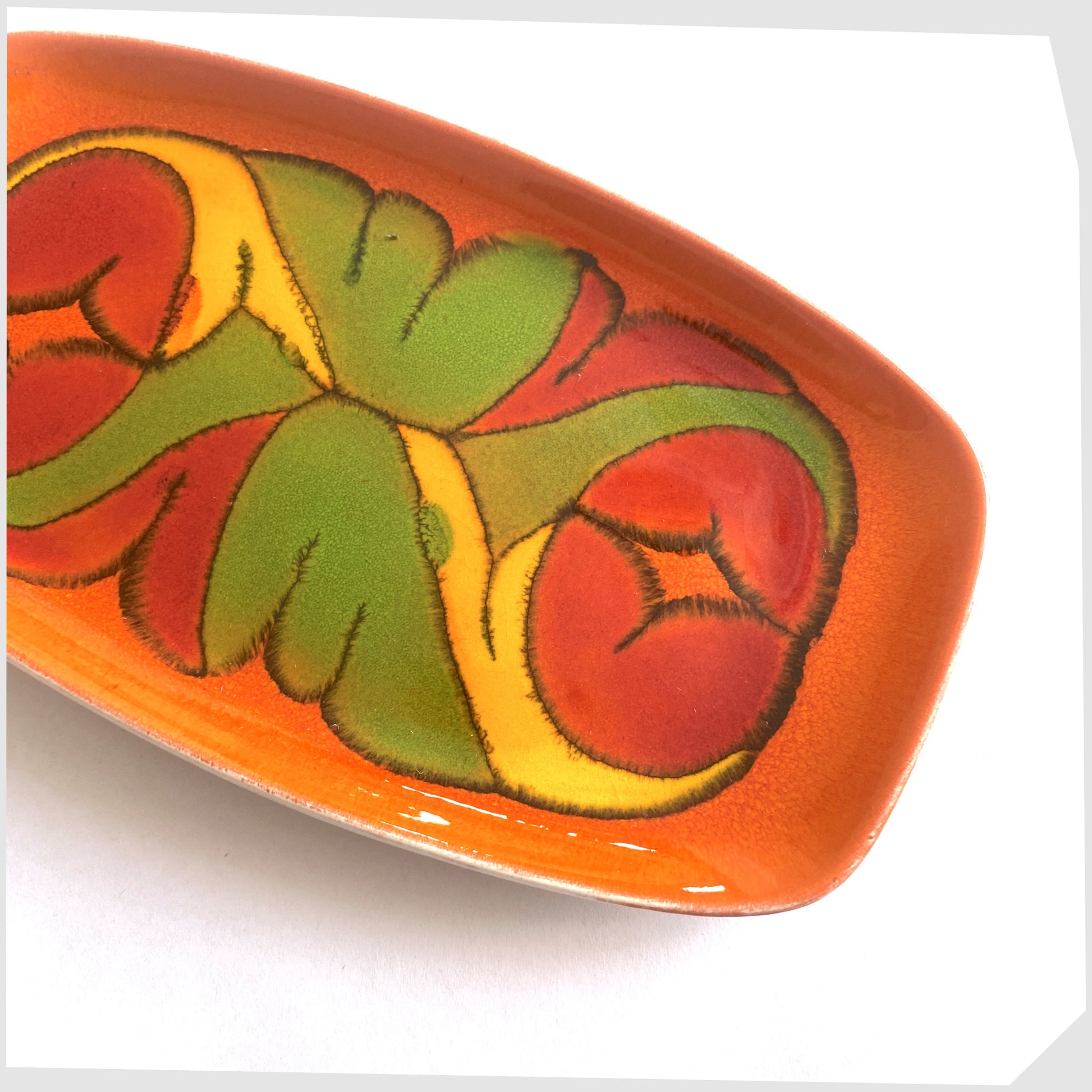 poole pottery delphis dish, shape 361, in a rich orange glaze with flowing forms of red green and yellow
