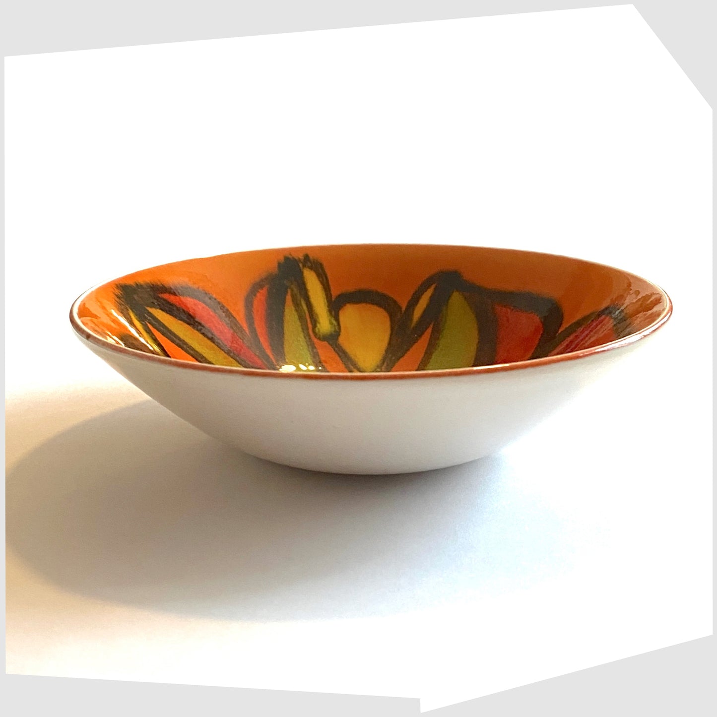 vintage Poole Pottery Delphis Bowl, shape 56, by Cynthia Bennett, glazed in a vivid orange with arching forms of green, red, yellow and green.