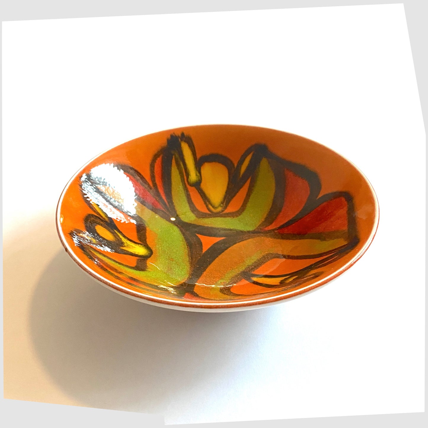 Poole Pottery Delphis Bowl, shape 56, by Cynthia Bennett, glazed in a vivid orange with arching forms of green, red, yellow and green.