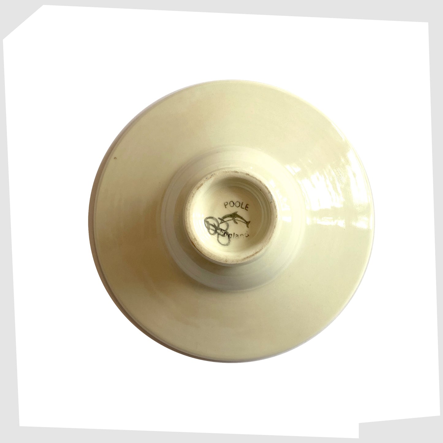 rear stamp on the poole pottery delphis candleholder in a vivid yellow glaze with circular forms of red and orange glaze