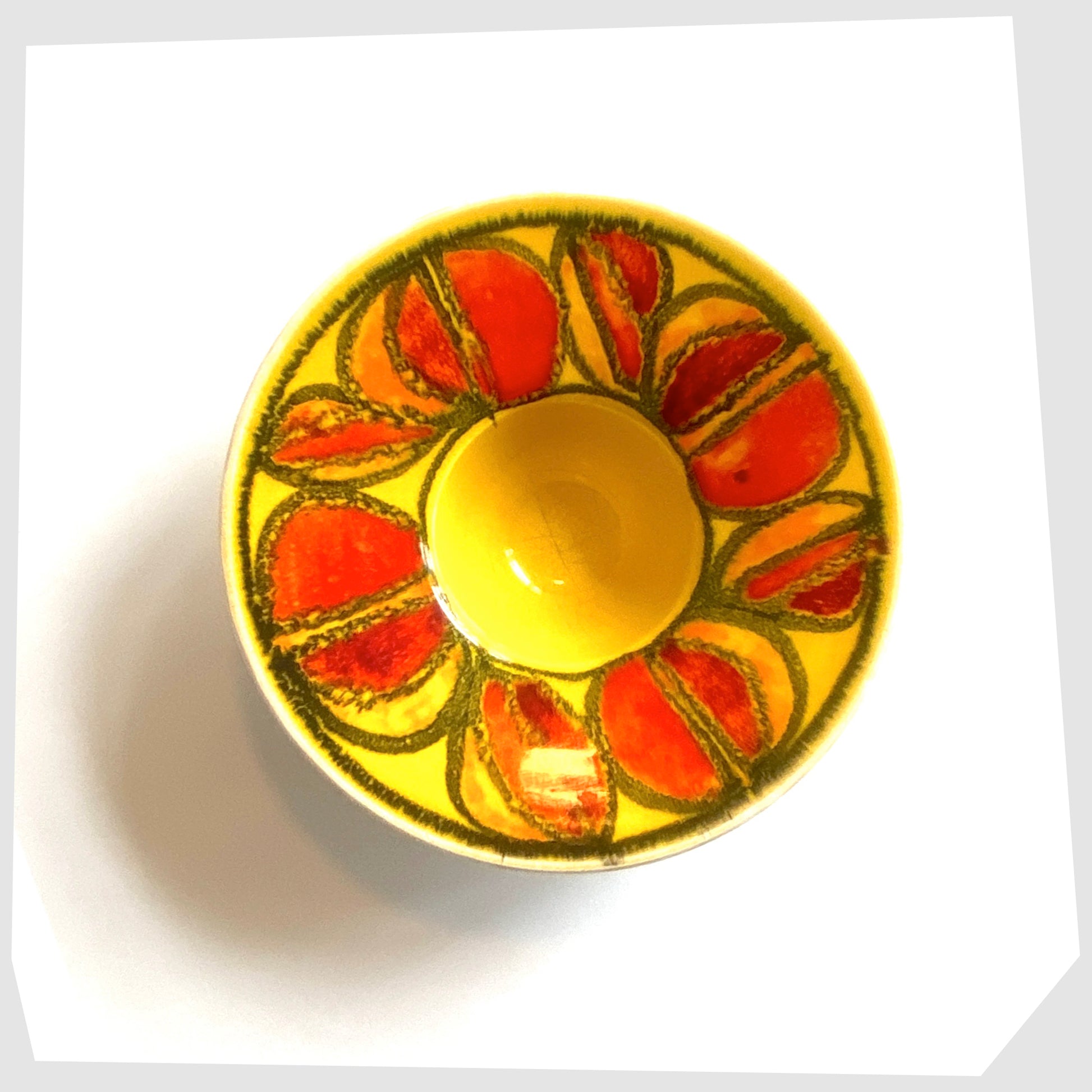 poole pottery delphis candleholder in a vivid yellow glaze with circular forms of red and orange glaze