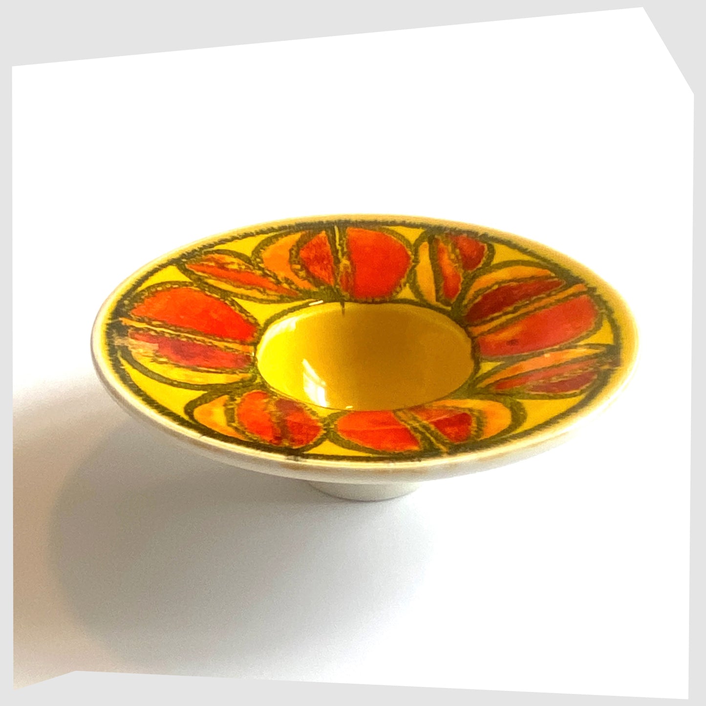 vintage poole pottery delphis candleholder in a vivid yellow glaze with circular forms of red and orange glaze