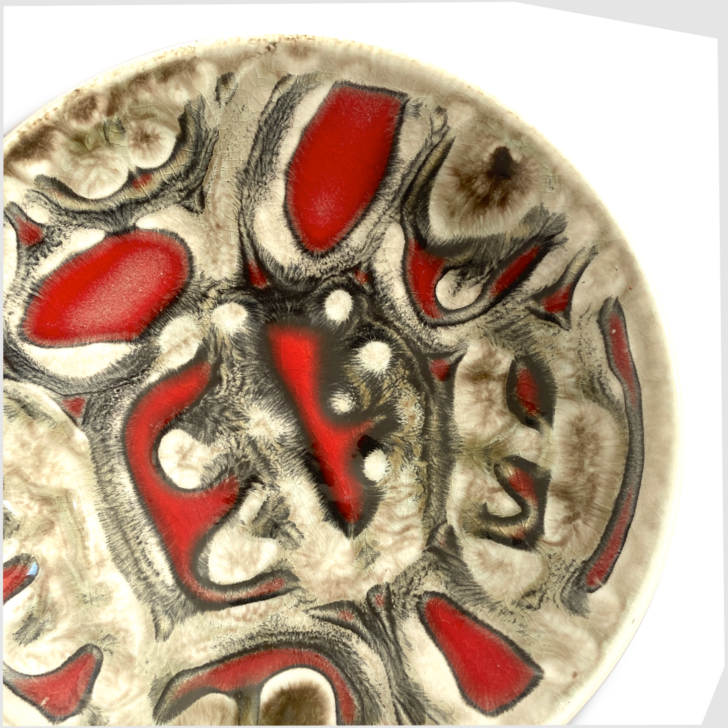 close up of the Poole Pottery Delphis Pin Dish by Patricia Wells in rich red with lines of warm grey