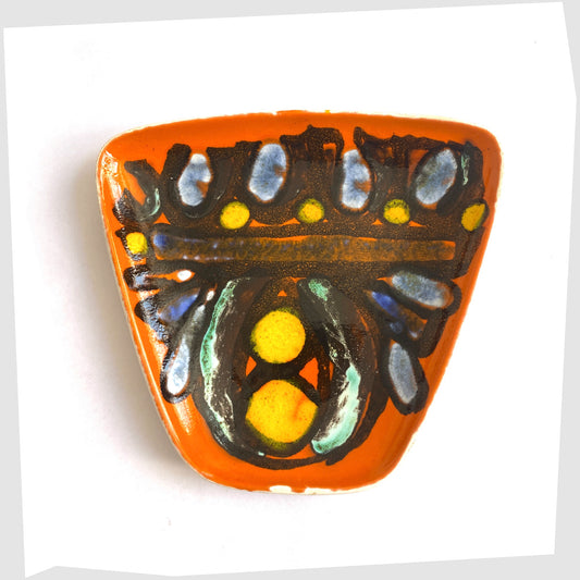 poole pottery delphis dish, shape 81, glazed in a vibrant orange with black lines framing yellow and blue circles
