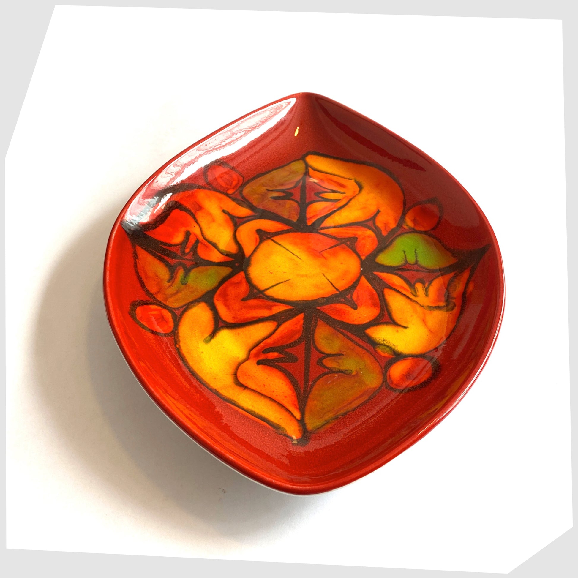 1960s poole pottery delphis teardrop-shaped dish, shape 91, in vivid red glaze with orange and green forms
