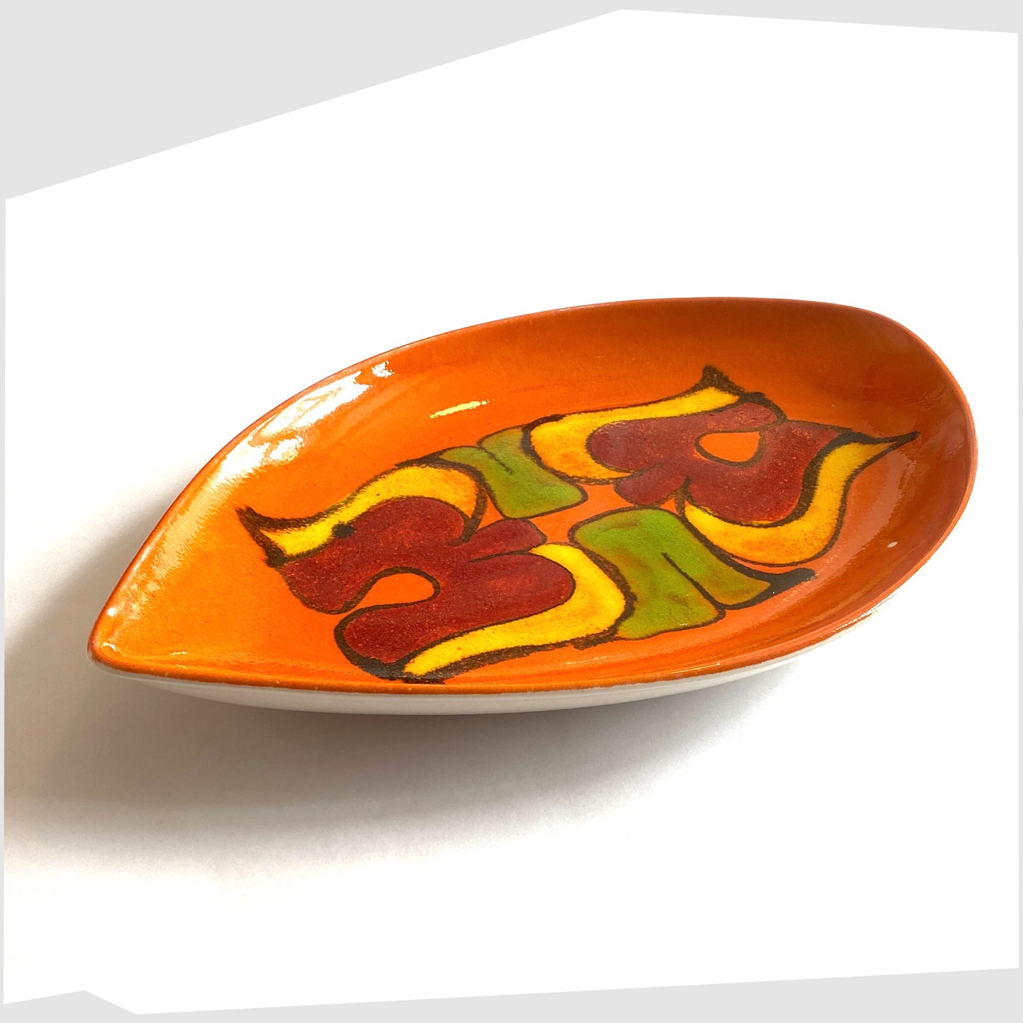 vintage poole pottery teardrop shaped decorative dish, decorated in an orange delphis glaze with fluid shapes of green, yellow and red