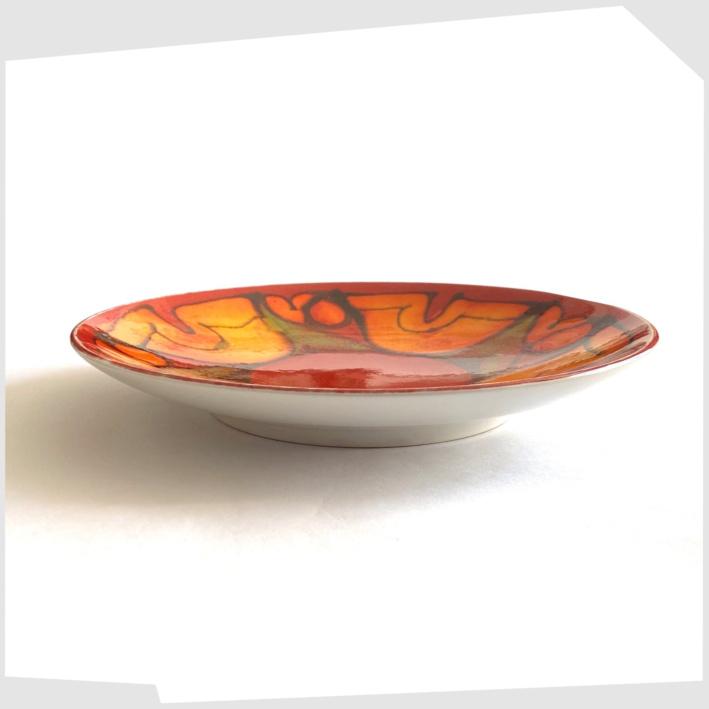 side profile of the Poole Pottery in the Delphis glaze of red with orange and green forms