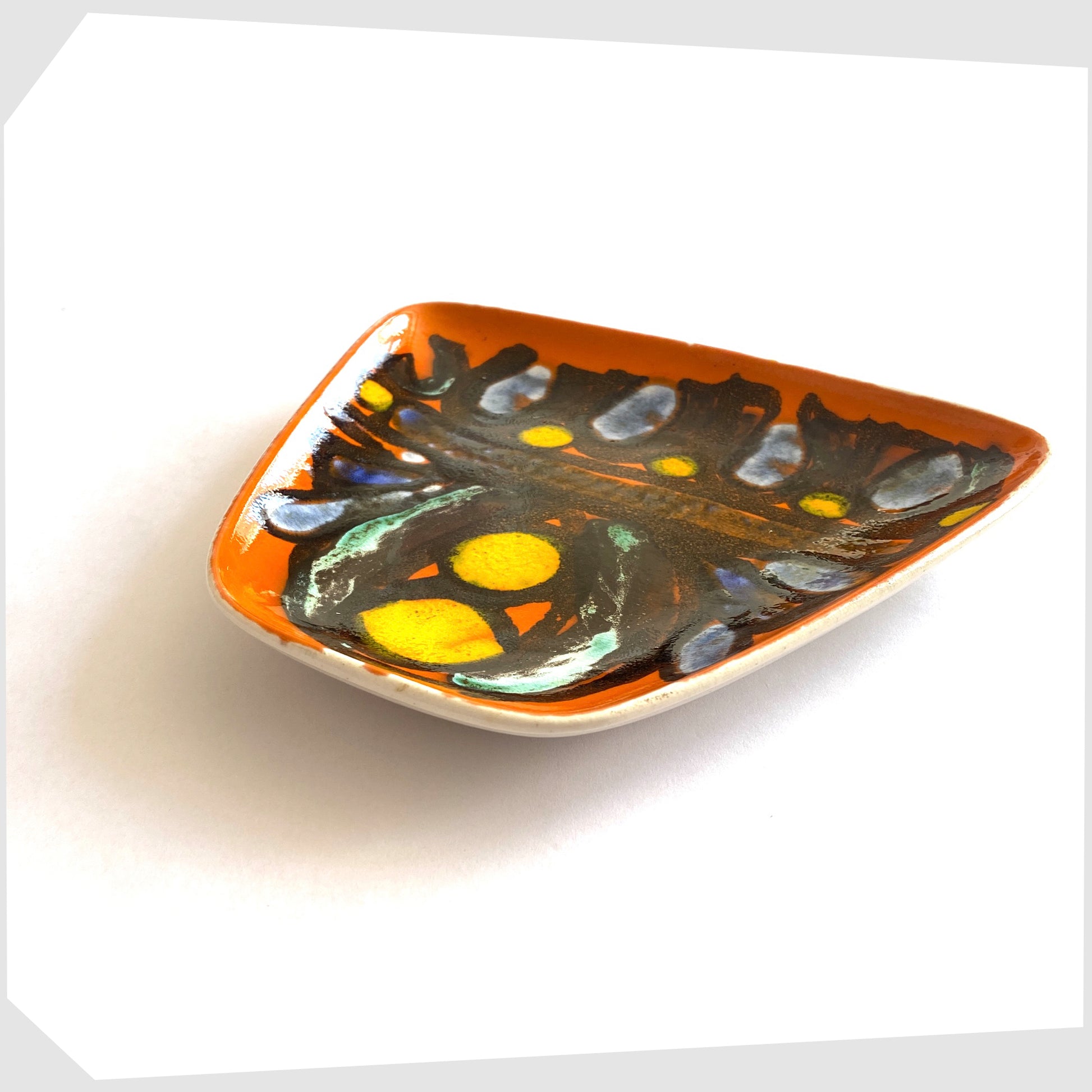 mid-century poole pottery delphis dish, shape 81, glazed in a vibrant orange with black lines framing yellow and blue circles