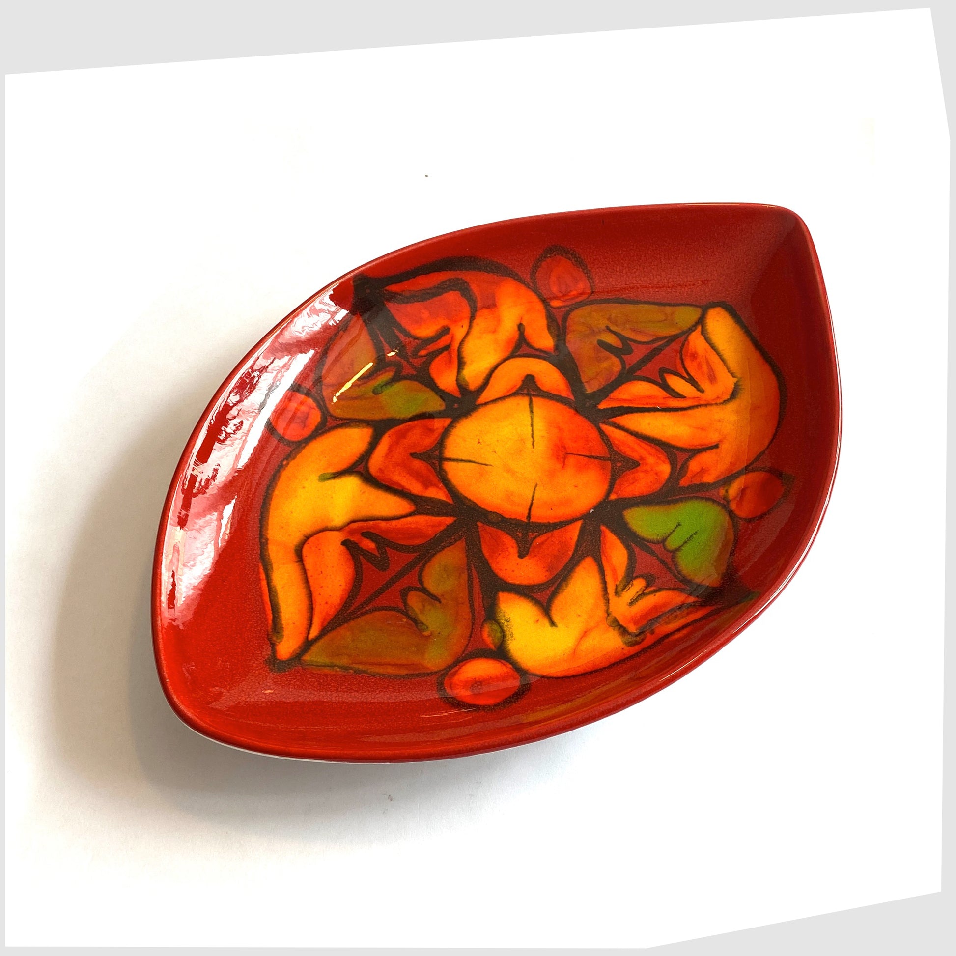 poole pottery delphis teardrop-shaped dish, shape 91, in vivid red glaze with orange and green forms