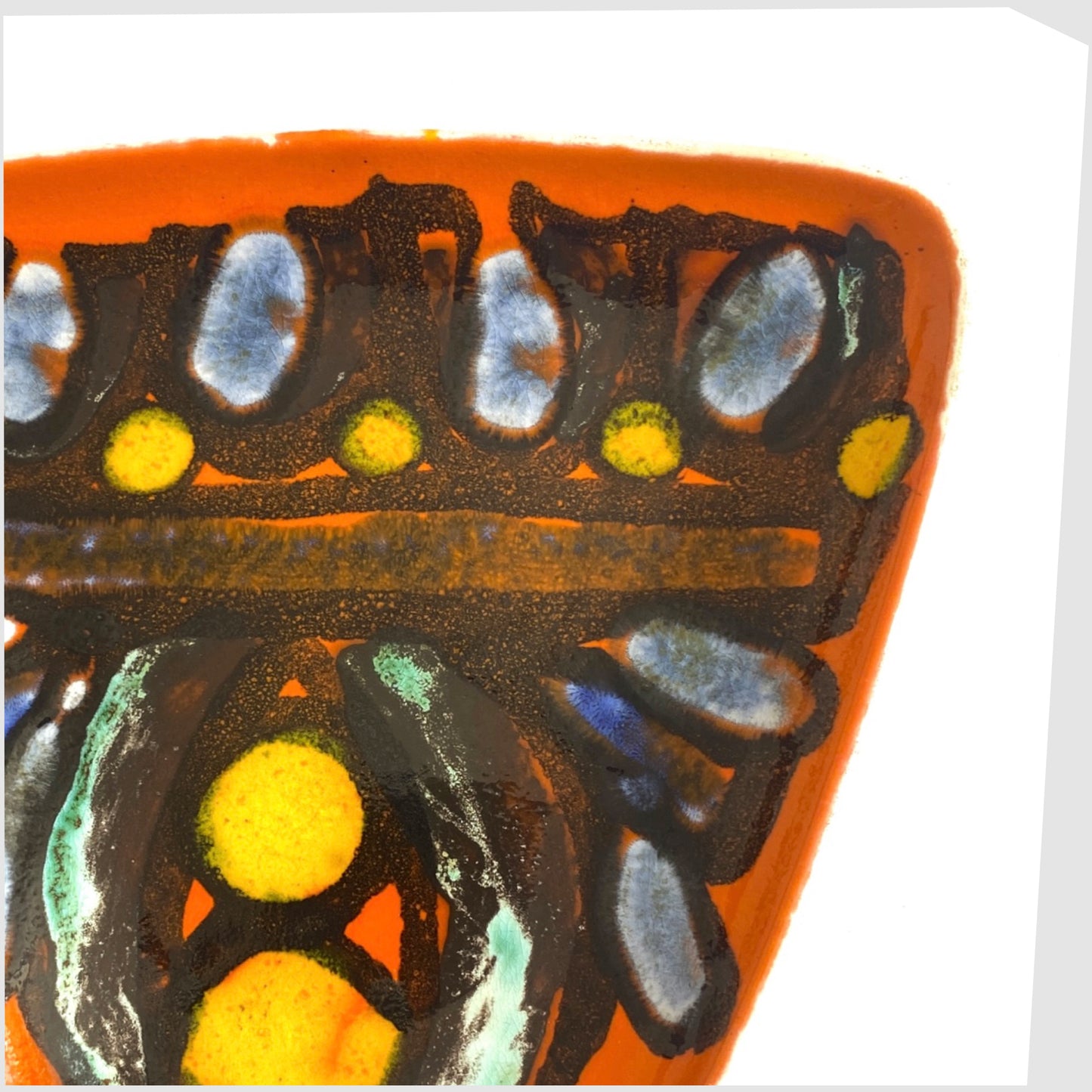 black lines framing yellow and blue circles on the orange poole pottery delphis dish, shape 81