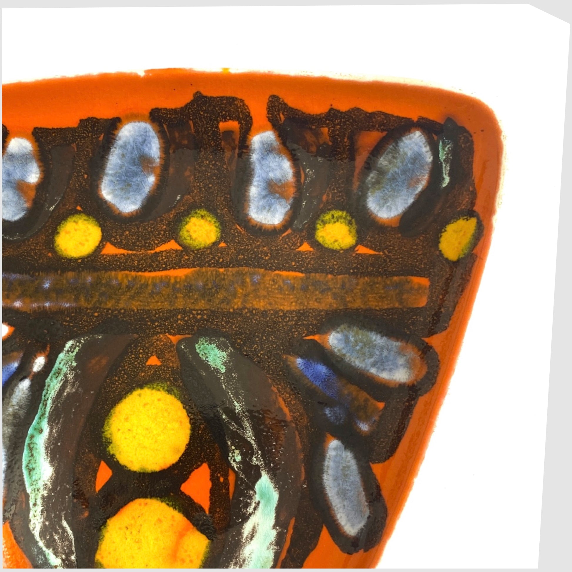 black lines framing yellow and blue circles on the orange poole pottery delphis dish, shape 81