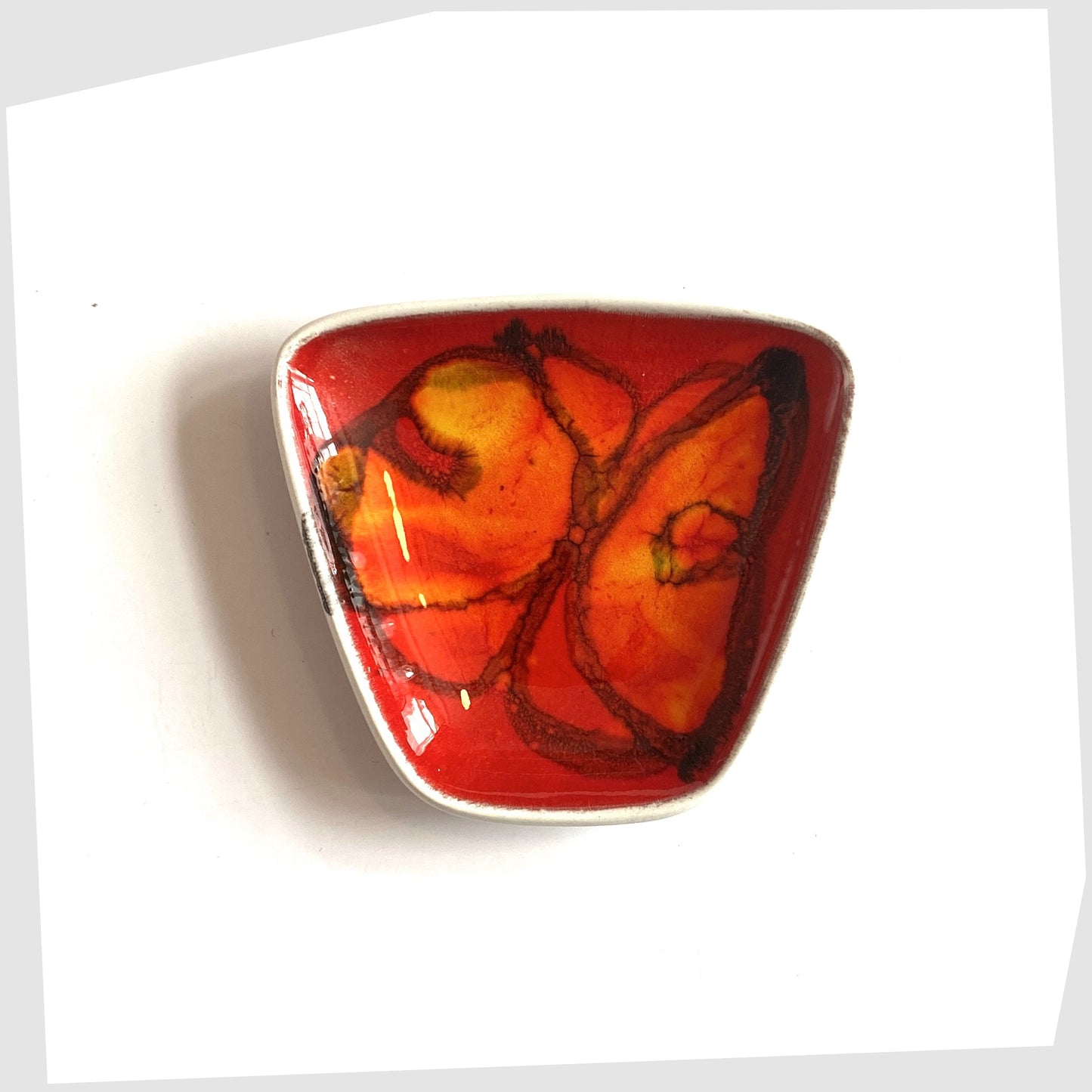 Poole Pottery Delphis Pin Dish by Anita Lawrence in a red glaze with orange and yellow shapes