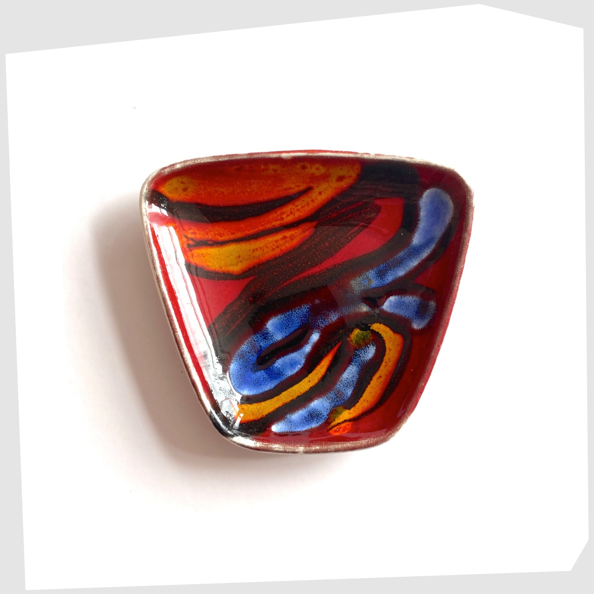 Poole Pottery Delphis Pin Dish, shape 41, by Loretta Leigh glazed in a rich red with fluid forms of blue, orange and yellow