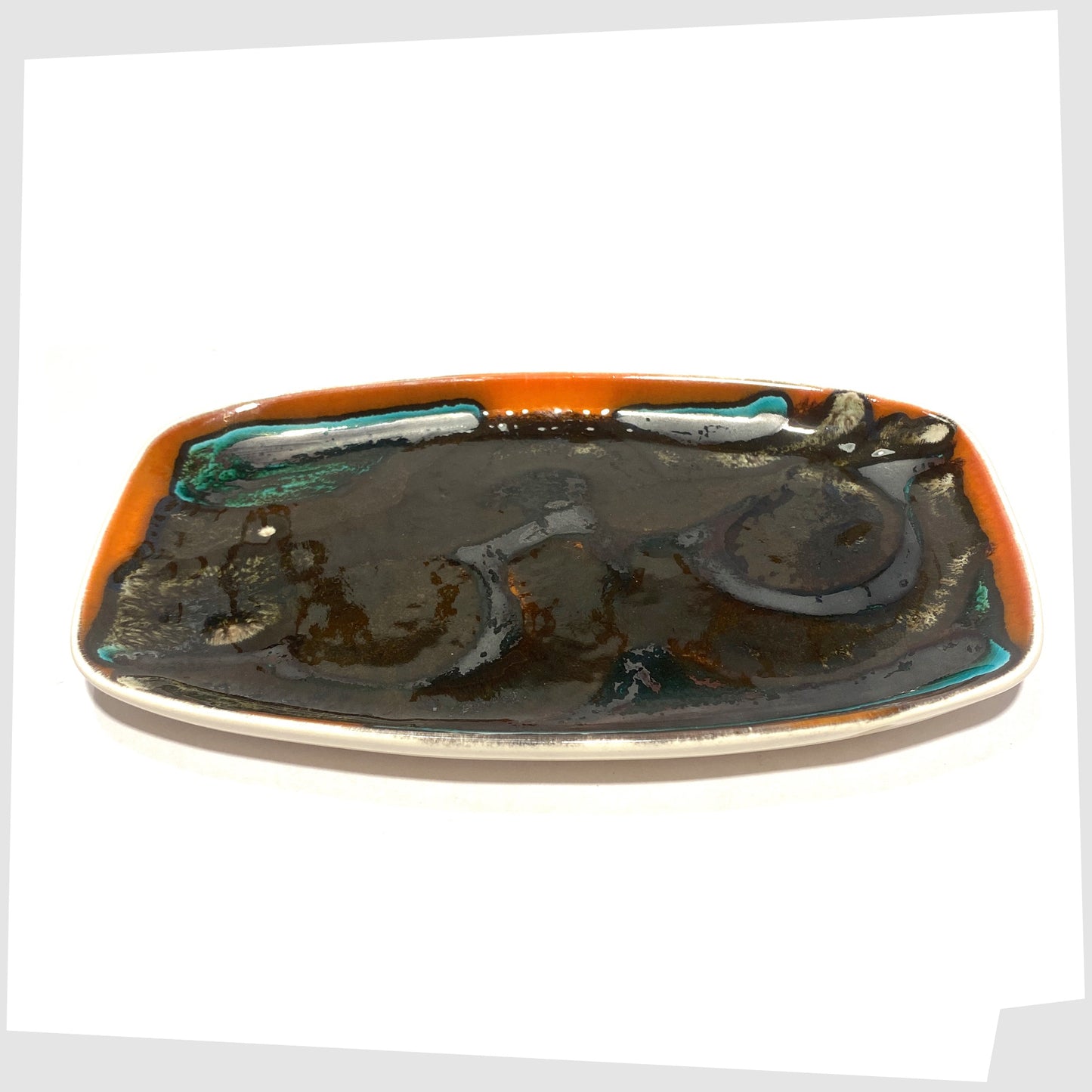 poole pottery delphis pin dish in black glaze framed with orange and teal