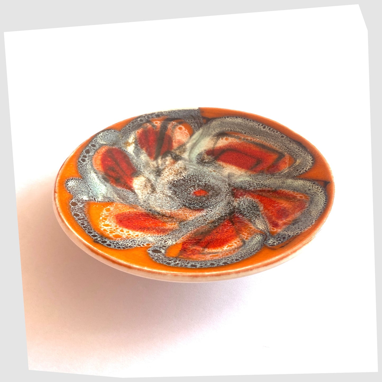 Late 1960s Poole Pottery Delphis Pin Dish by Jean Millership finished in a vibrant orange, blue and red glaze