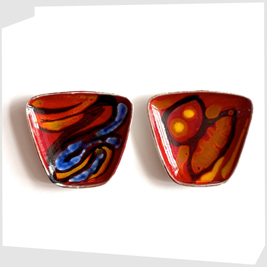 pair of Poole Pottery Delphis Pin Dishes, shape 41, by Loretta Leigh glazed in a rich red with fluid forms of blue, orange and yellow