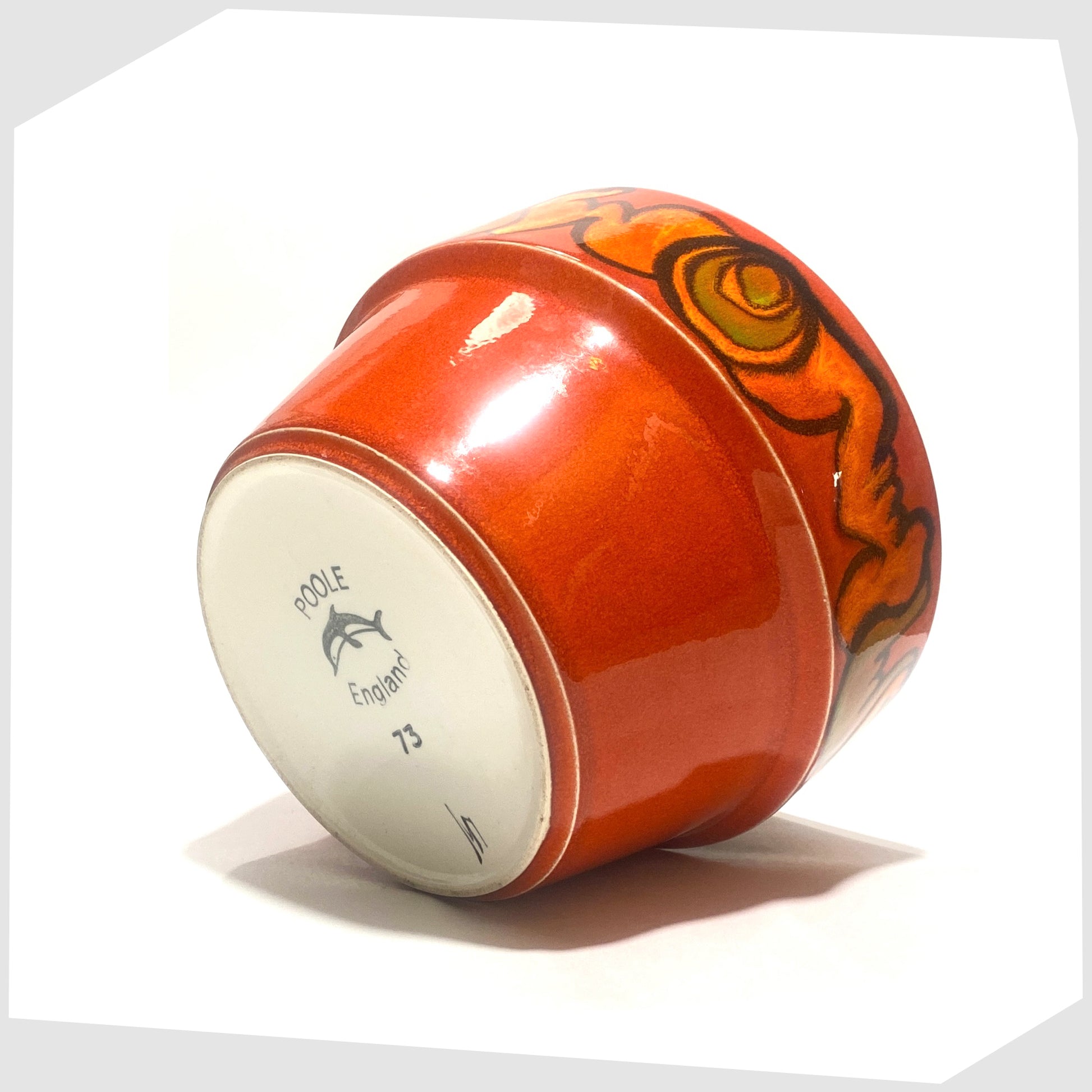 base of the poole pottery planter finished in a rich red glaze with orange and green forms around the rim