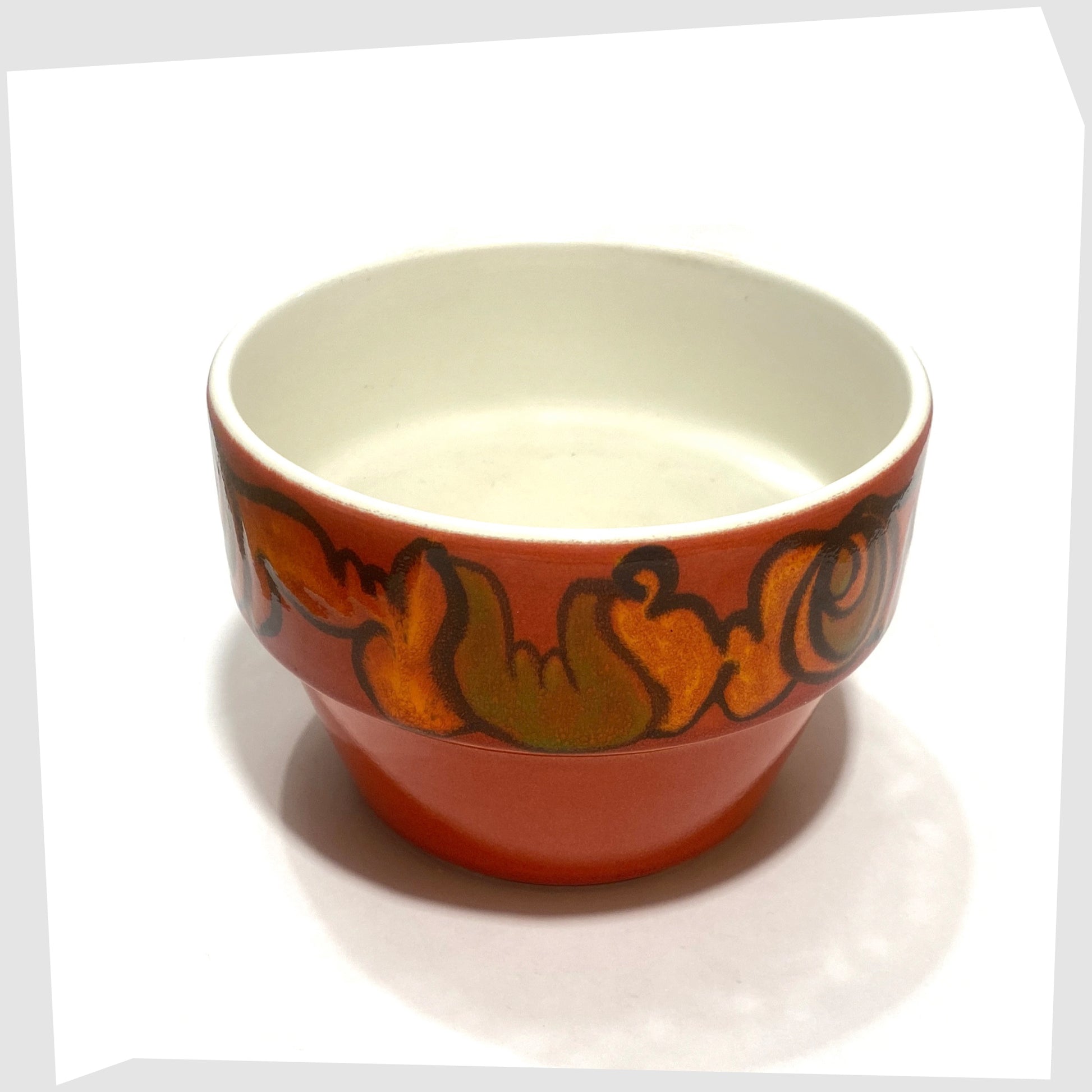 red poole pottery delphis planter finished in a rich red glaze with orange and green forms around the rim