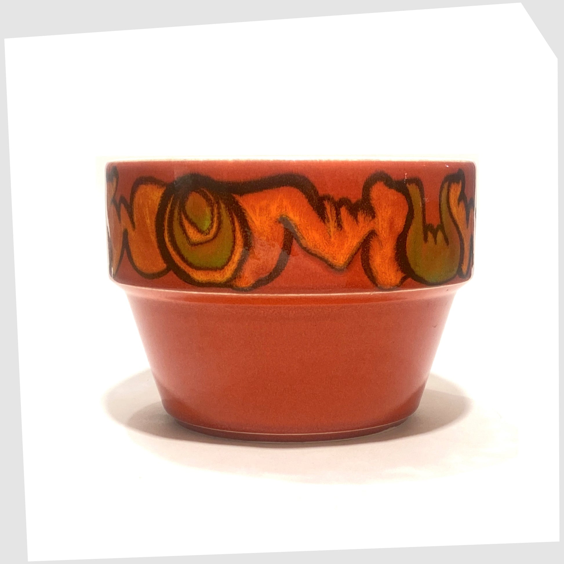 large poole pottery planter finished in a rich red glaze with orange and green forms around the rim
