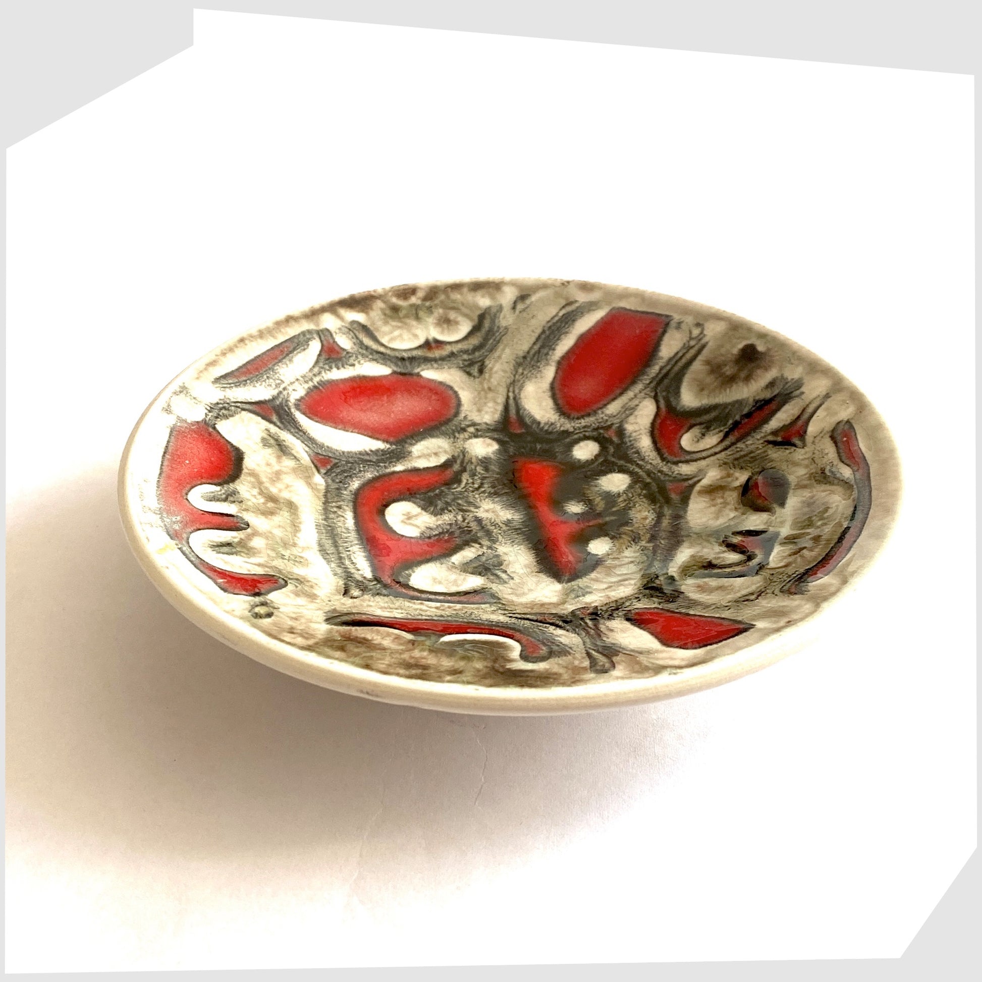 small round Poole Pottery Delphis Pin Dish by Patricia Wells in rich red with lines of warm grey