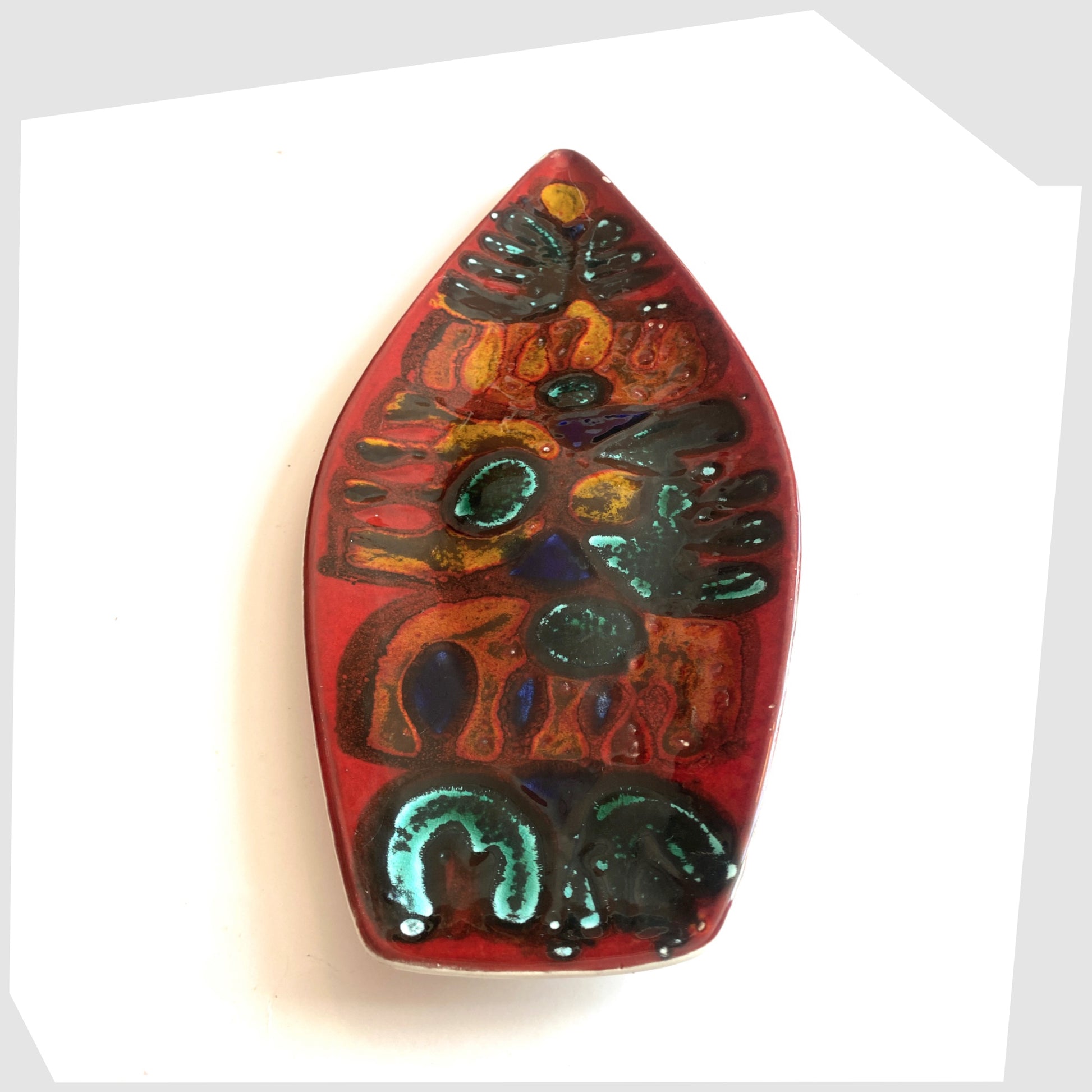 Late 1960s Poole Pottery Delphis Spear Dish, Shape 82, by paintress Irene Kerton finished in a vibrant red glaze with fluid forms of orange and turquoise, shown on a white background