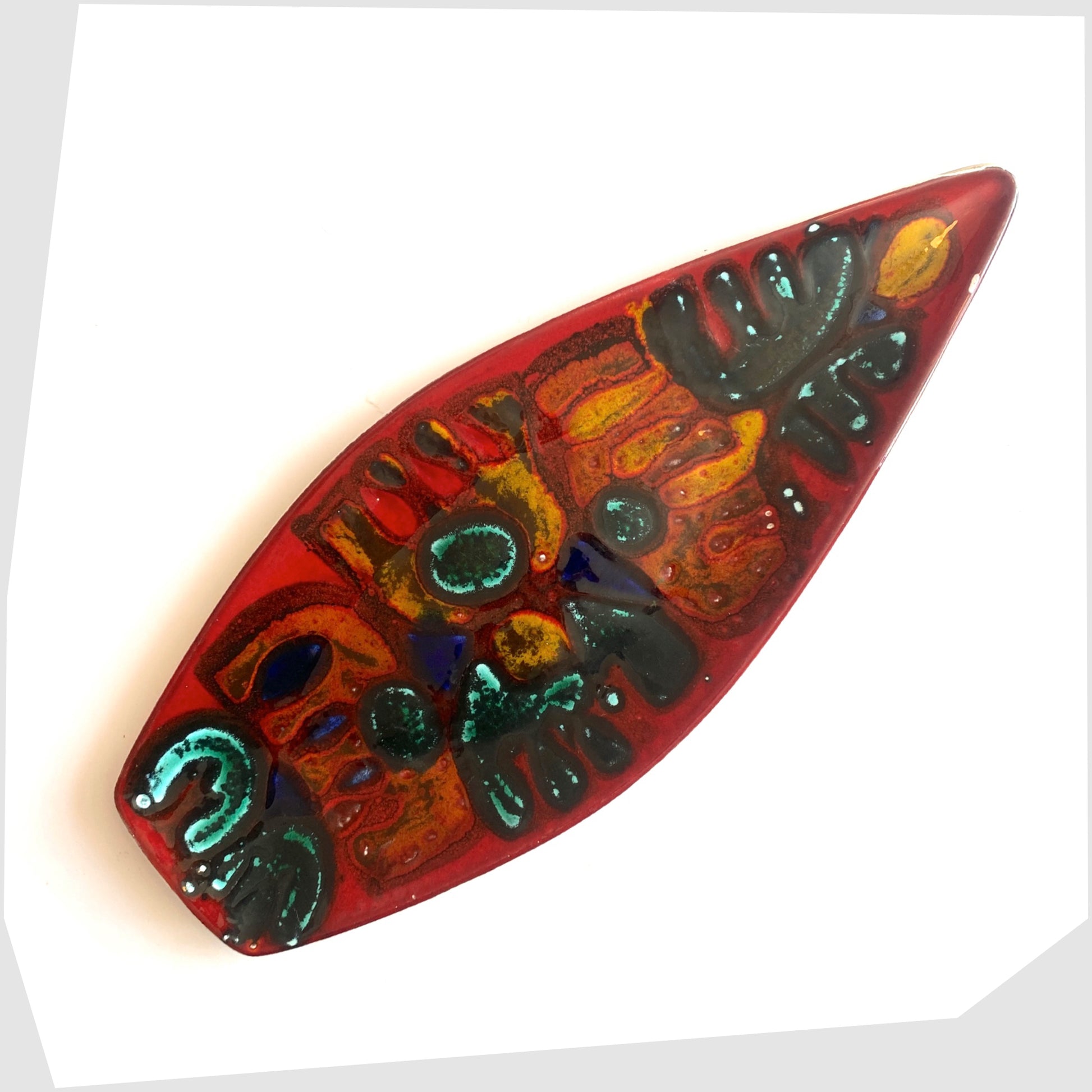 Poole Pottery Delphis Spear Dish, Shape 82, by paintress Irene Kerton finished in a vibrant red glaze with fluid forms of orange and turquoise, shown on a white background