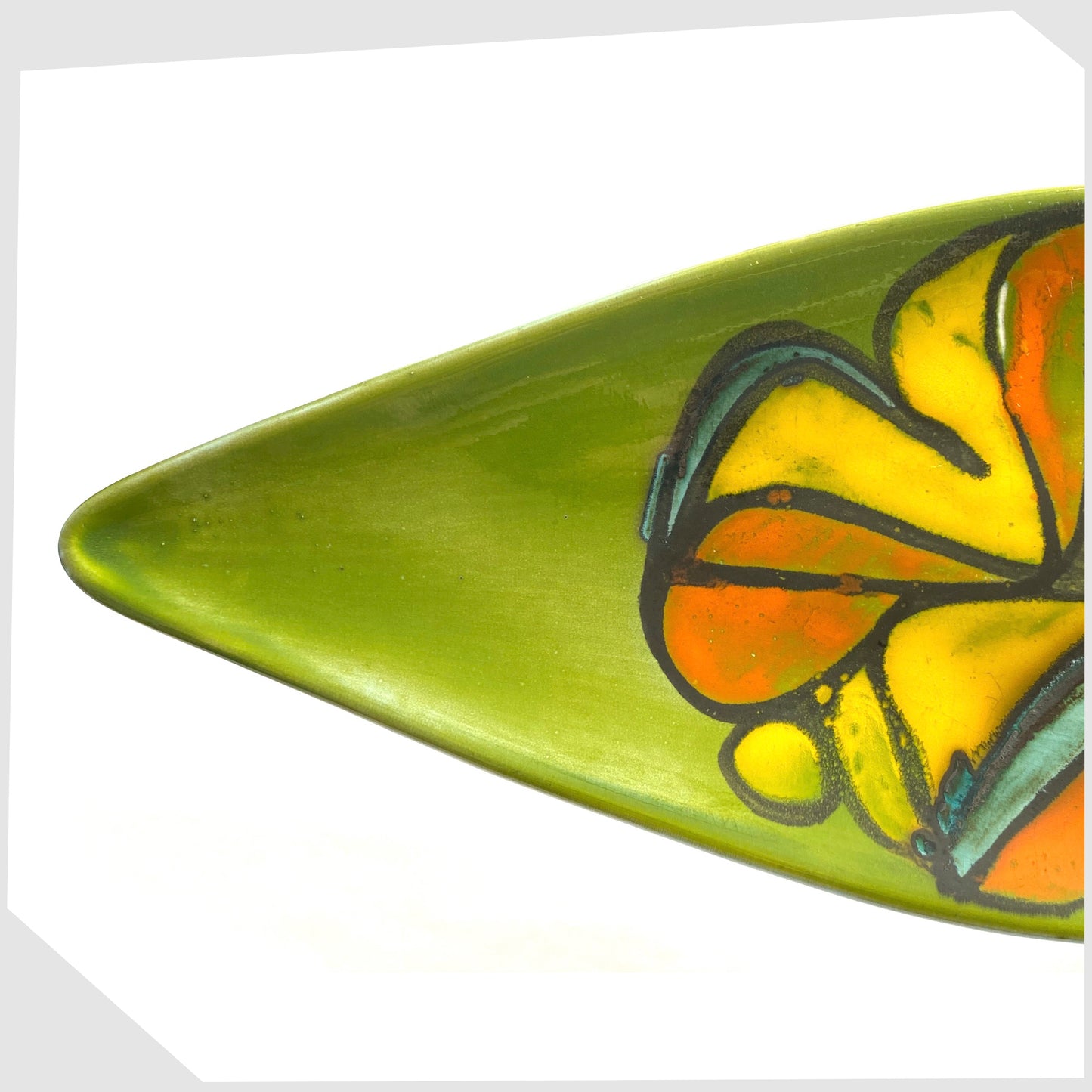 tip of the poole pottery delphis spear dish, shape 82 by Cynthia Bennett, in a rich green laze with free-forms shapes of orange and yellow