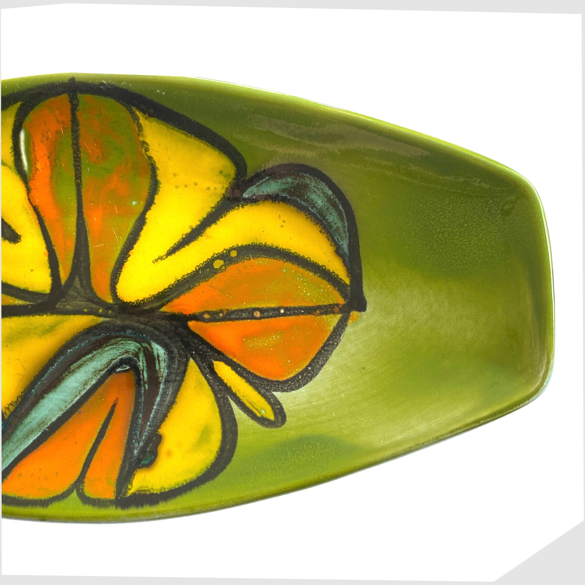 end of the poole pottery delphis spear dish, shape 82 by Cynthia Bennett, in a rich green laze with free-forms shapes of orange and yellow