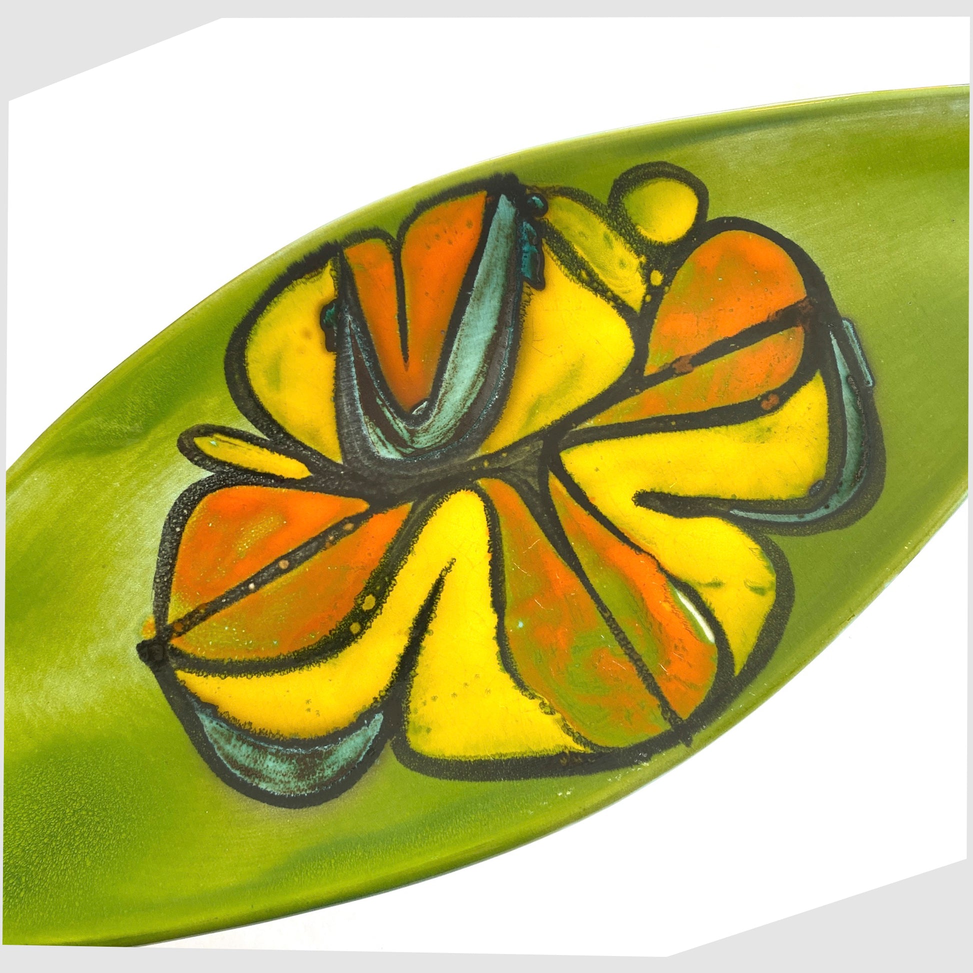 close up of the poole pottery delphis spear dish, shape 82 by Cynthia Bennett, in a rich green laze with free-forms shapes of orange and yellow