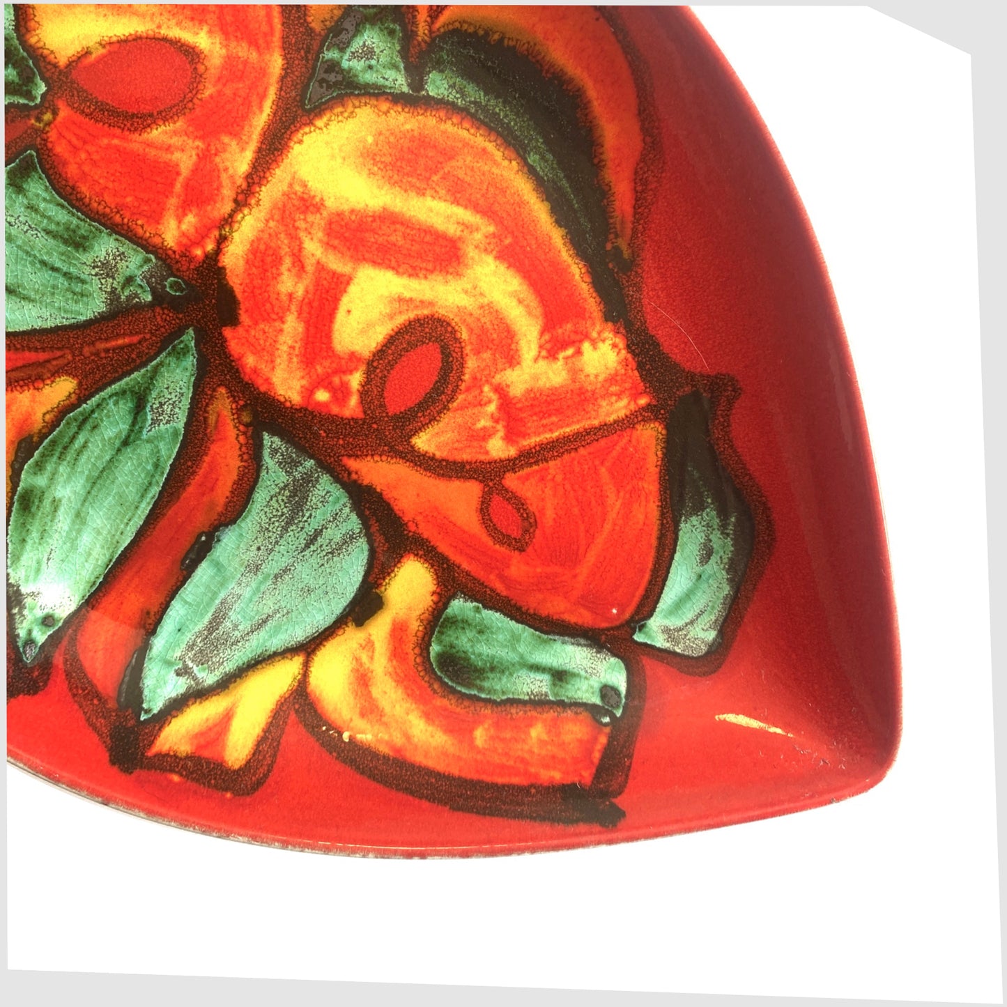 1960s Poole Pottery Delphis Teardrop Dish, shape 91, decorated by Angela Wyburgh, in a red glaze with green and orange forms