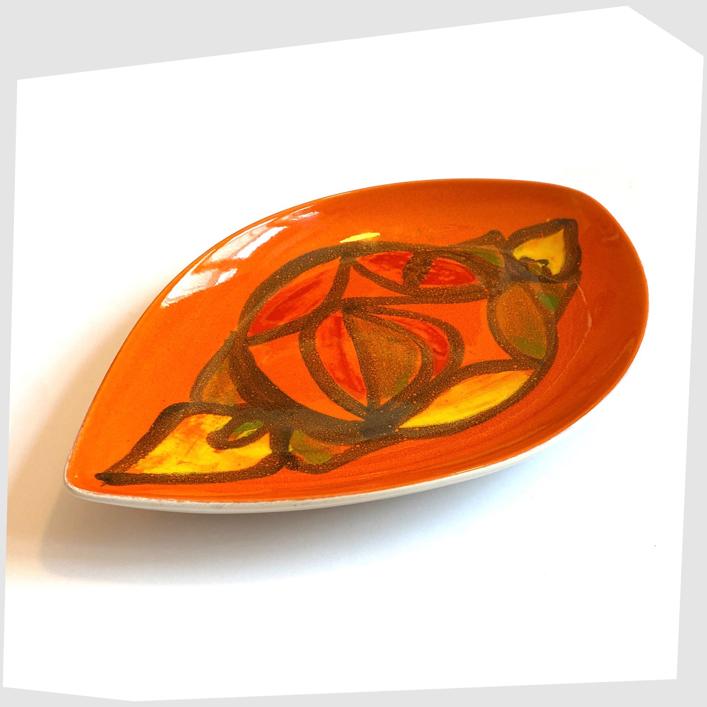 1970s Poole Pottery Delphis Teardrop Dish by Anita Lawrence in an orange glaze with fluid forms of red, yellow and green