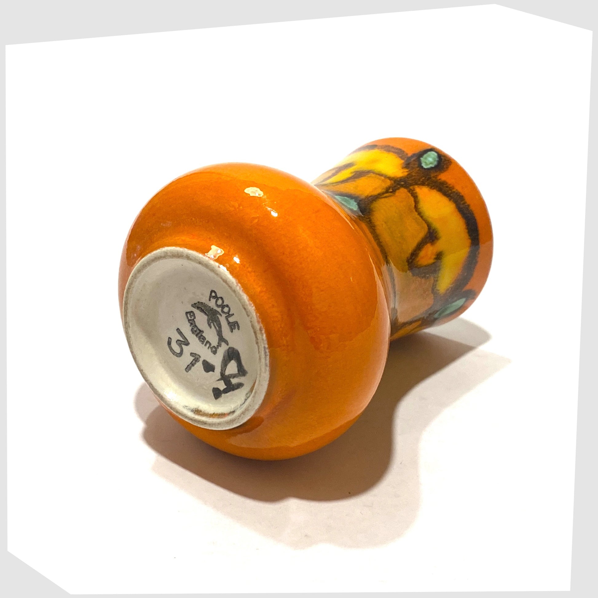 base of the poole pottery delphis vase, shape 31, in a vivid orange glaze with green and yellow forms