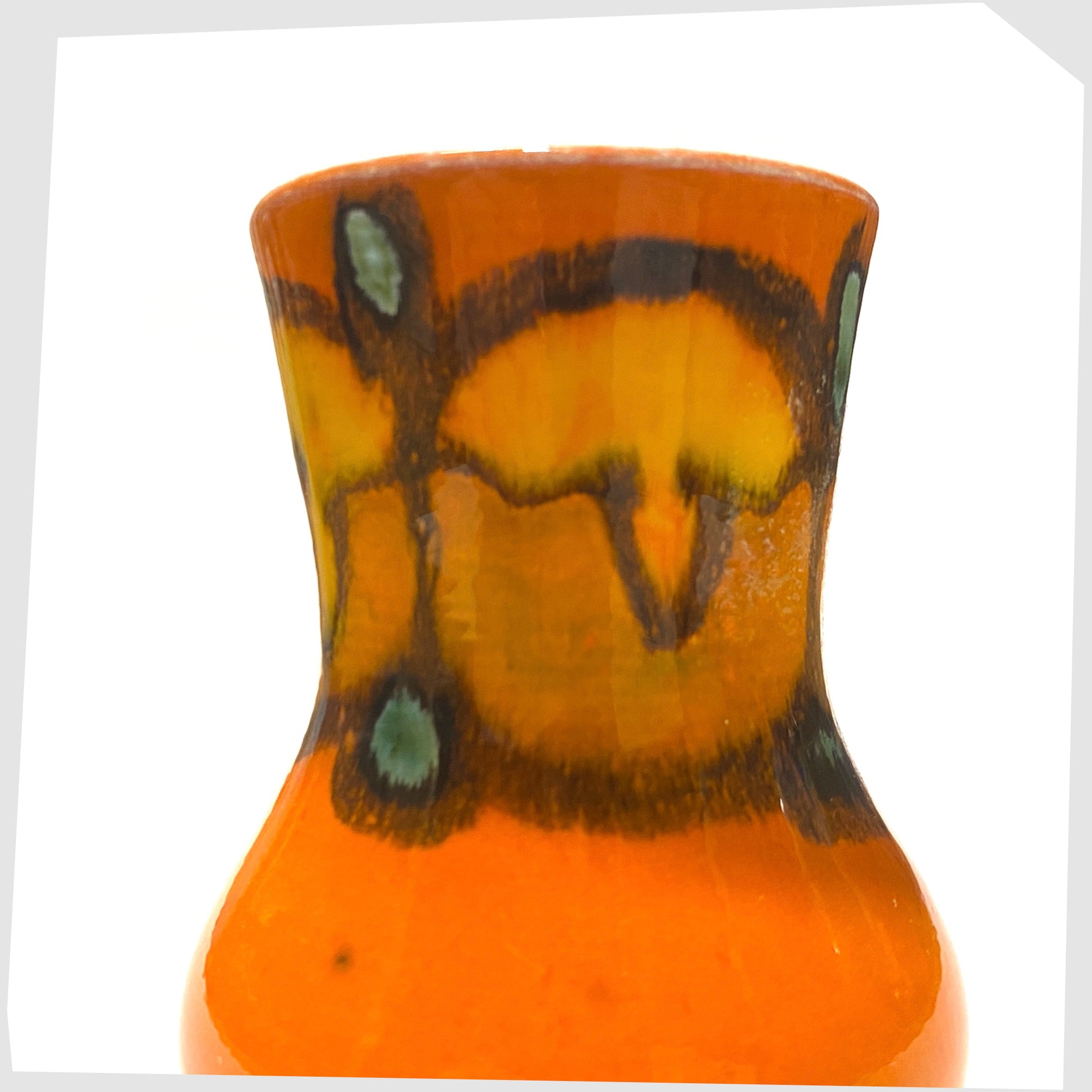 close up of the poole pottery delphis vase, shape 31, in a vivid orange glaze with green and yellow forms