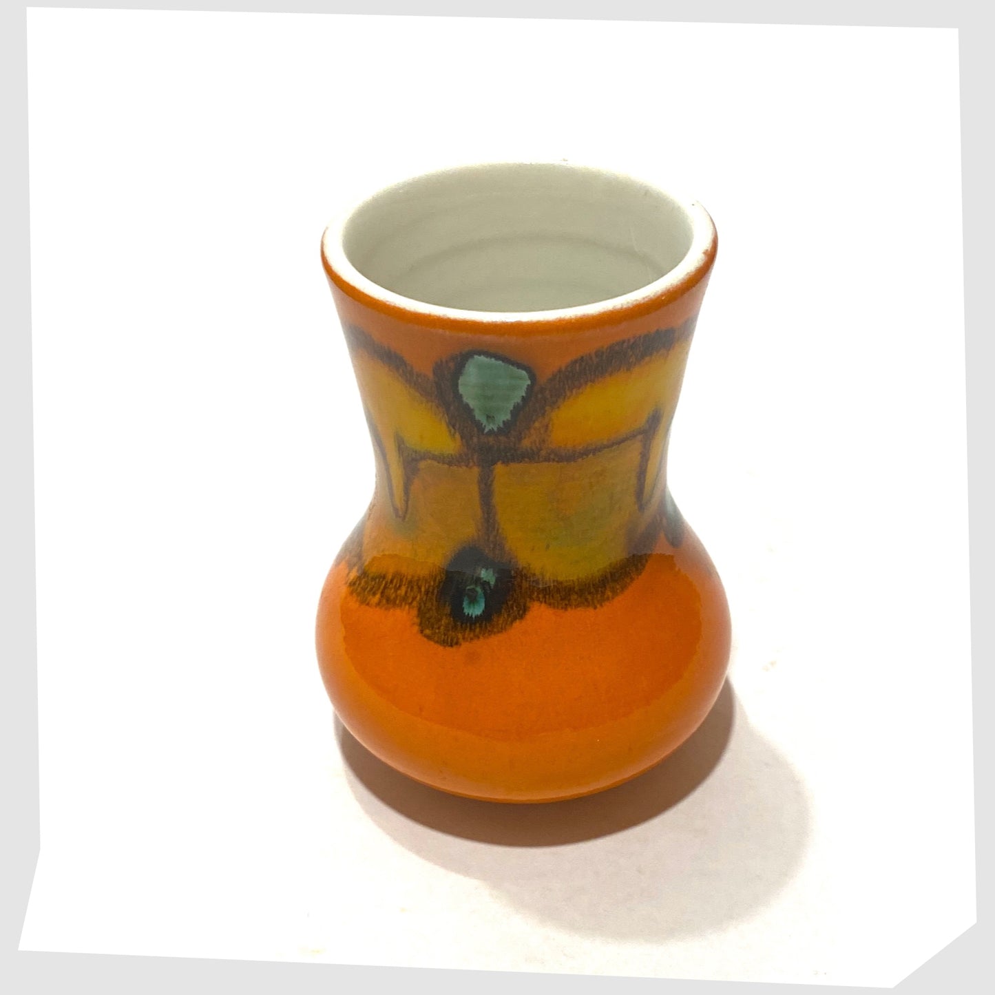 top rim of the poole pottery delphis vase, shape 31, in a vivid orange glaze with green and yellow forms
