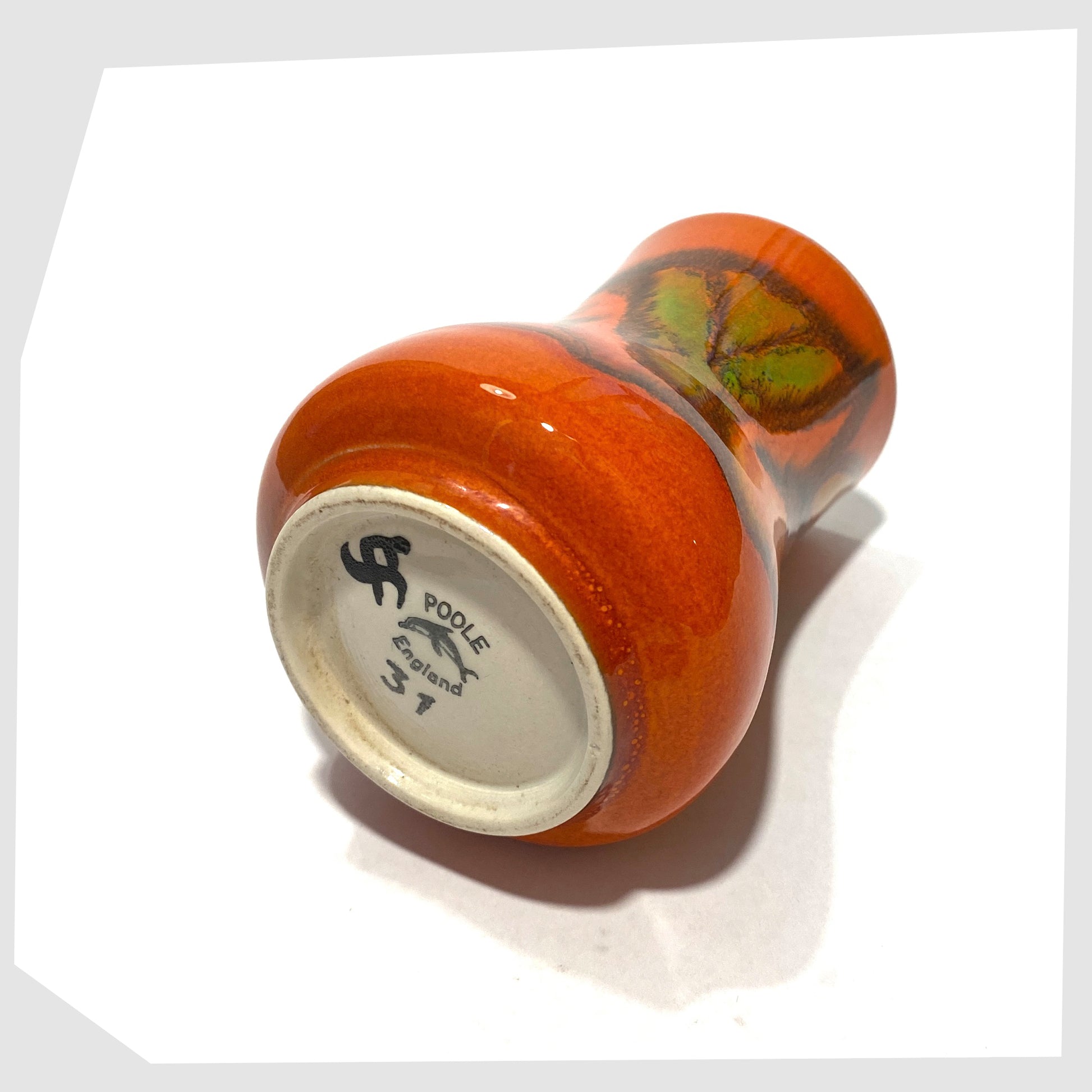 Base of the Poole Pottery Delphis Vase, Shape 31, by Tina Fancy- glazed in a rich burnt orange with fluid forms of yellow, green and red, shown on a white background