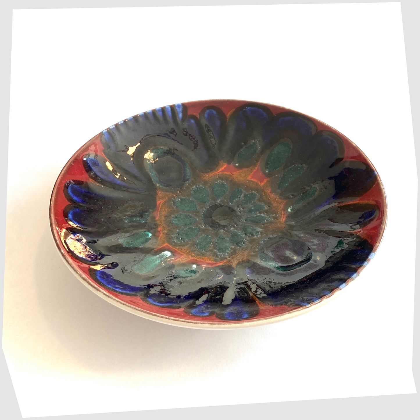 Poole Pottery Shape 3 Dish by Carloyn Bartlett glazed in a radiating design of red, cobalt blue and teal green