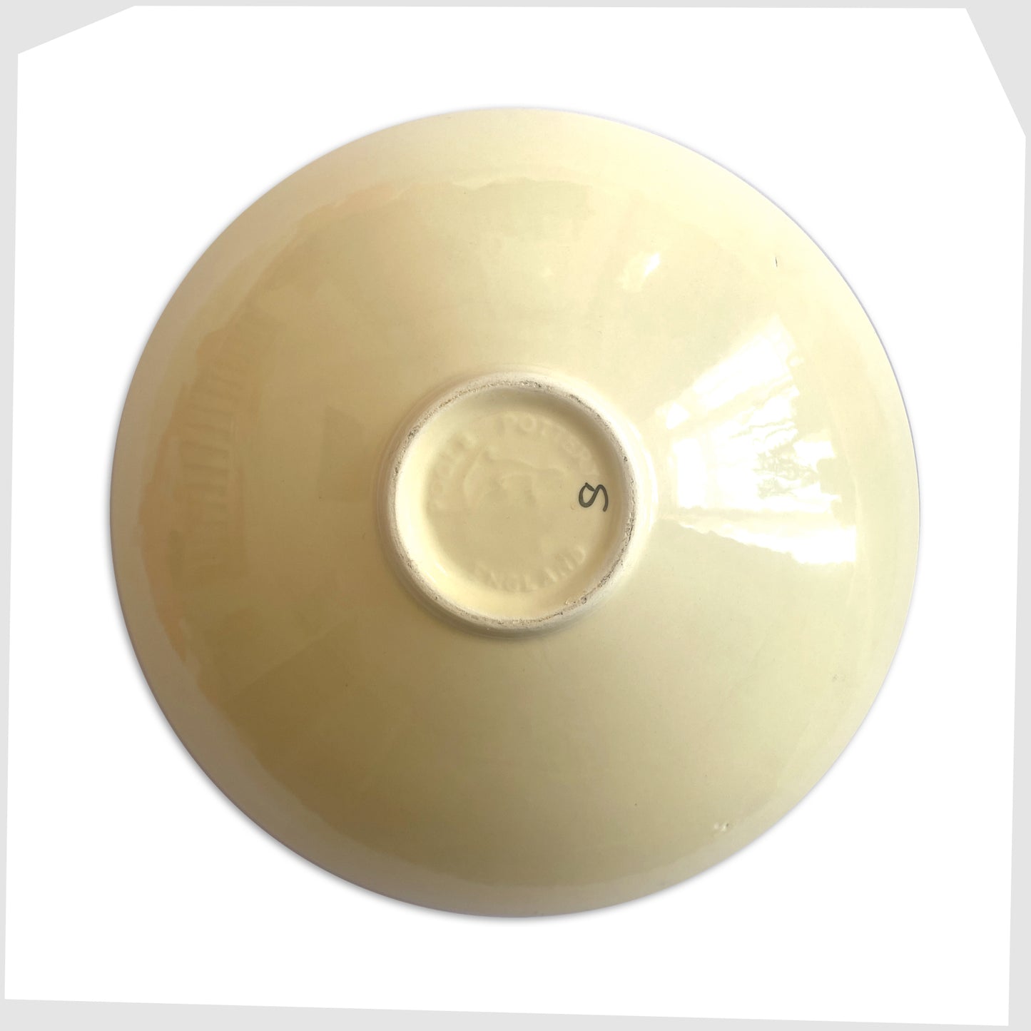 rear of the poole pottery gemstones dish glazed in an artistic pattern of orange, red, blue and green