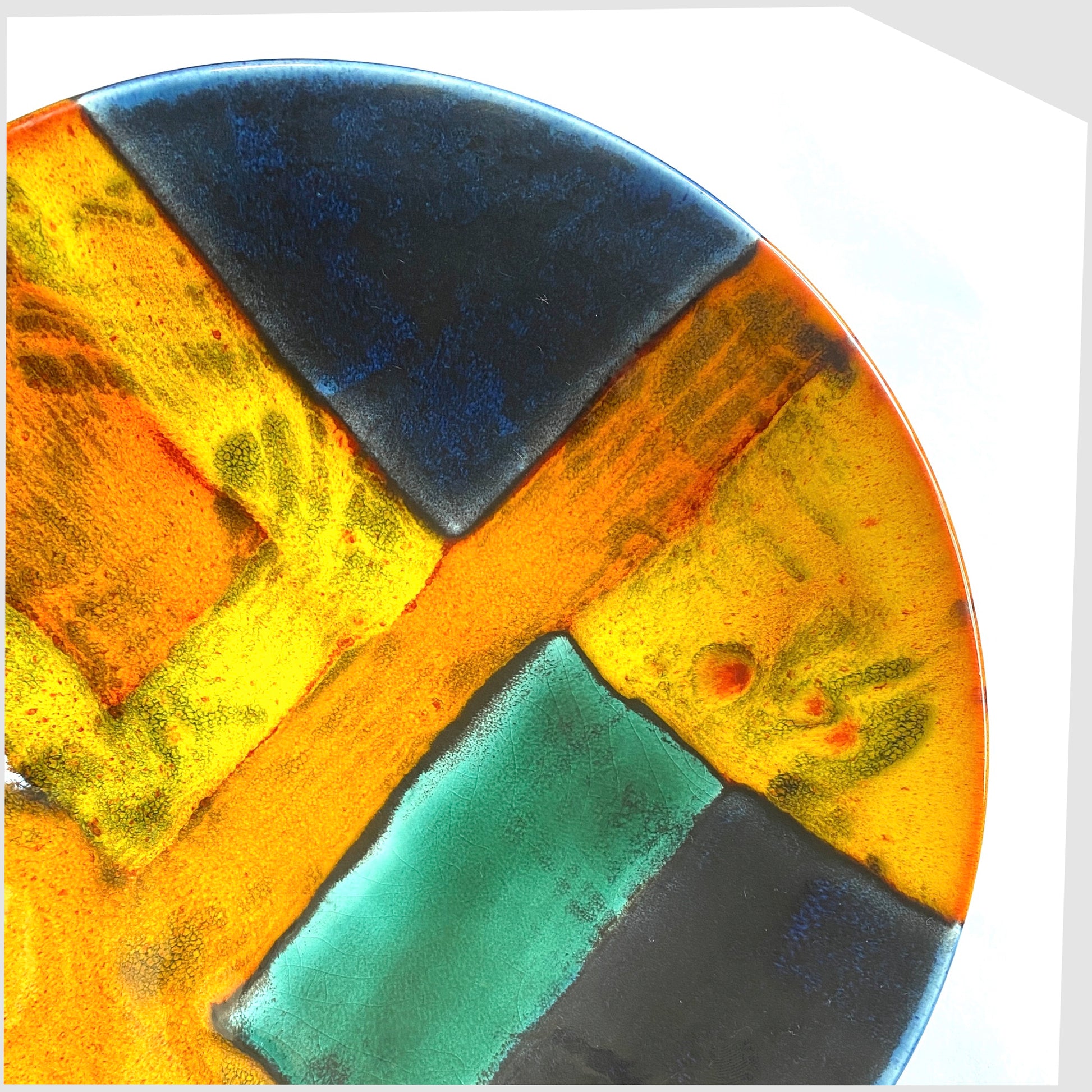 detail of the glazing on the poole pottery gemstones dish glazed in squares of orange, yellow, blue and green glaze
