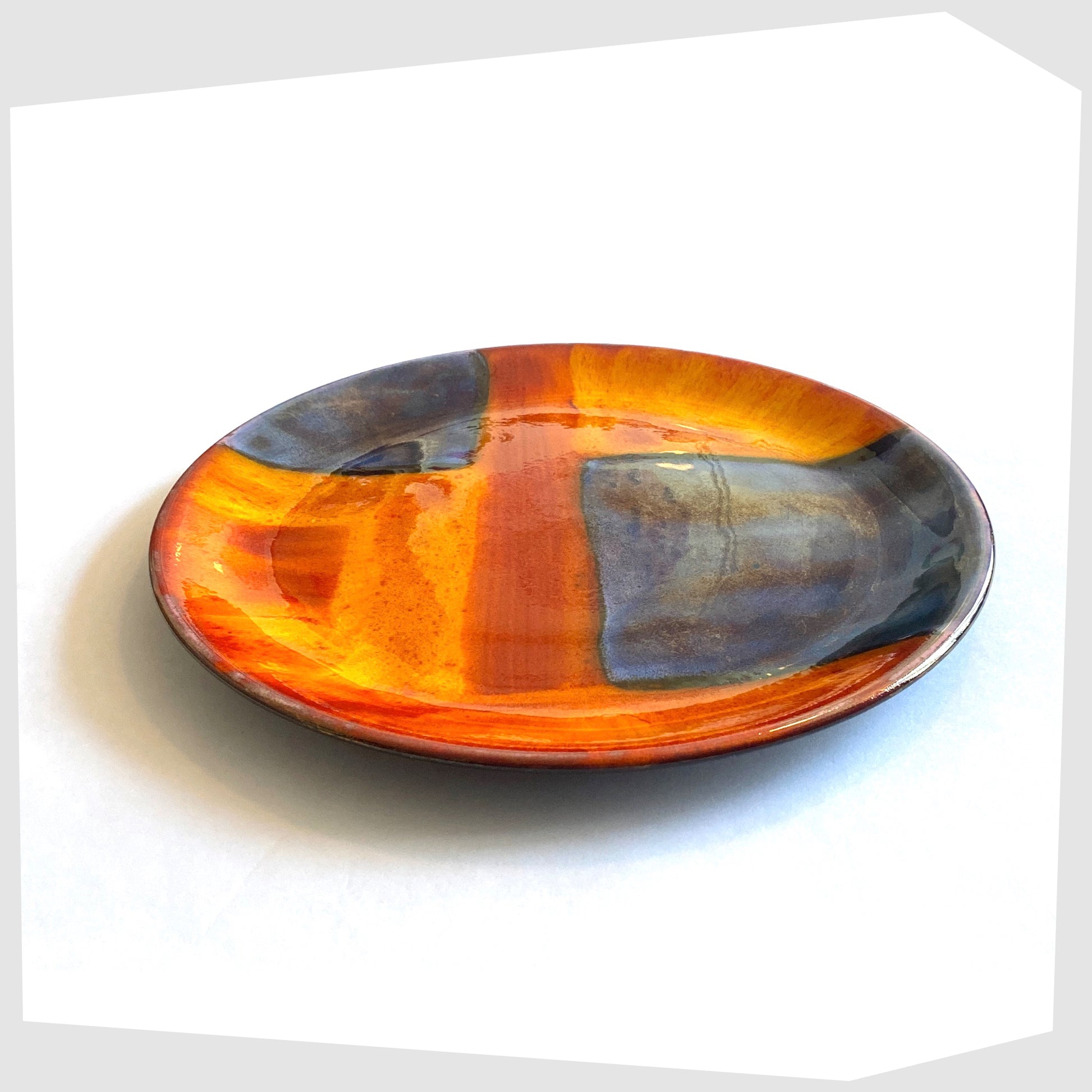 poole pottery plate in gemstones glaze of rich orange, red and blue squares