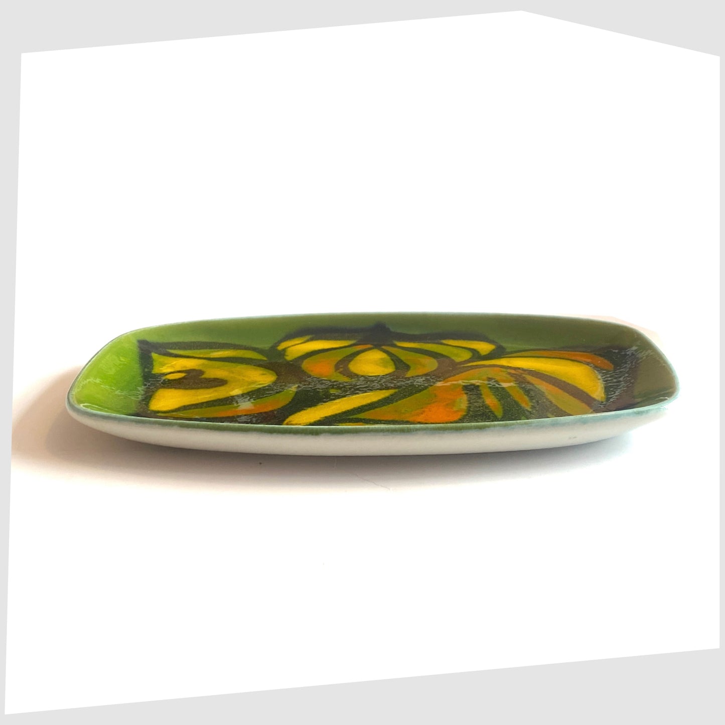 side profile of the Poole Pottery Delphis Dish, Shape 361 by Cynthia Bennett in a green glaze with yellow and orange forms