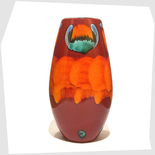 poole pottery manhattan vase finished in the volcano glaze of rich red, with flowing forms of orange, blue and green