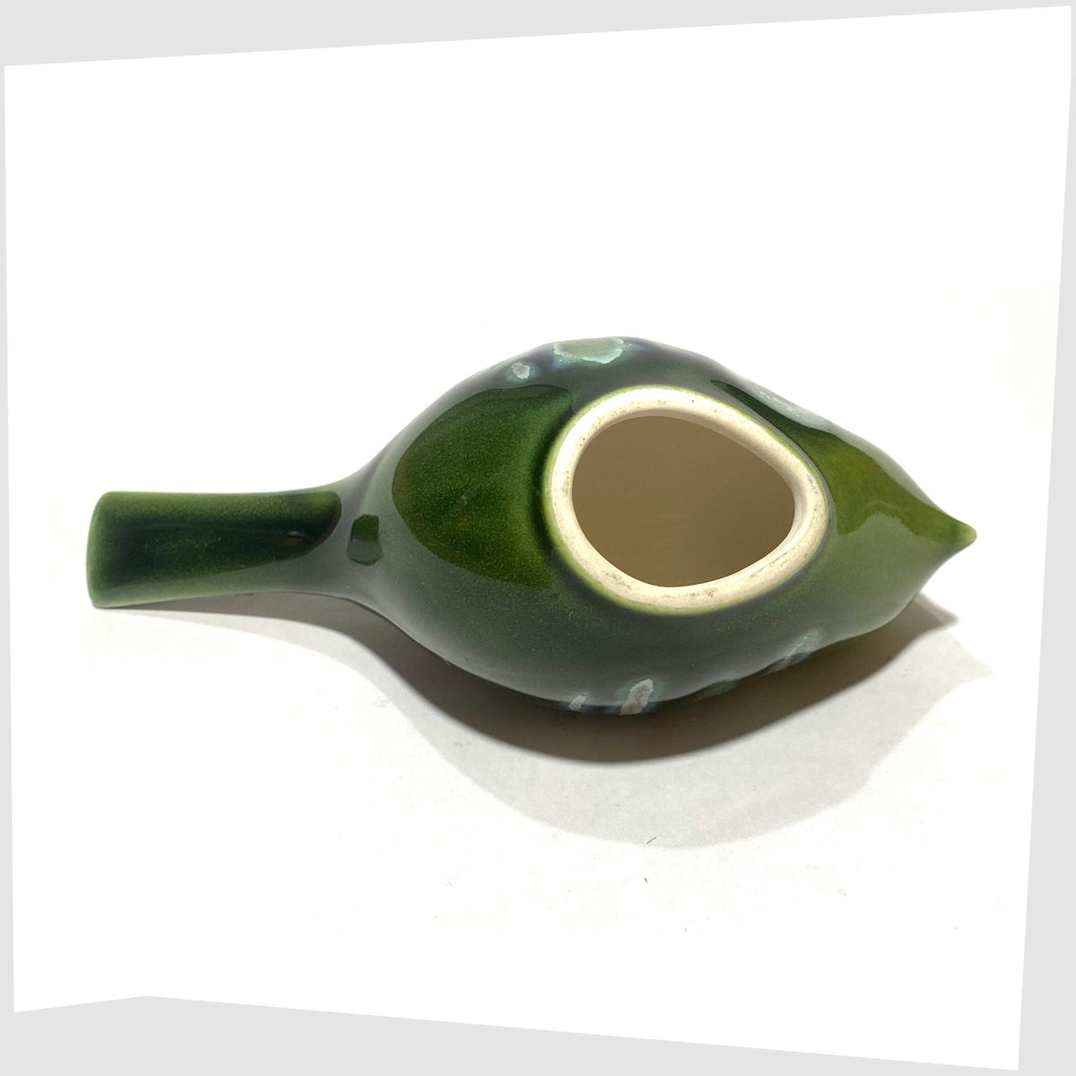 Base of the Poole Pottery Pecking Bird Figurine in Maya glaze of green, blue and grey, shown on a white background