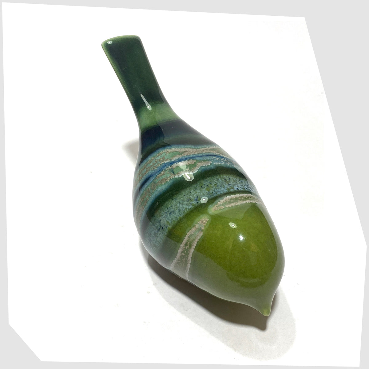 Poole Pottery Pecking Bird Ornament in Maya glaze of green, blue and grey, shown on a white background