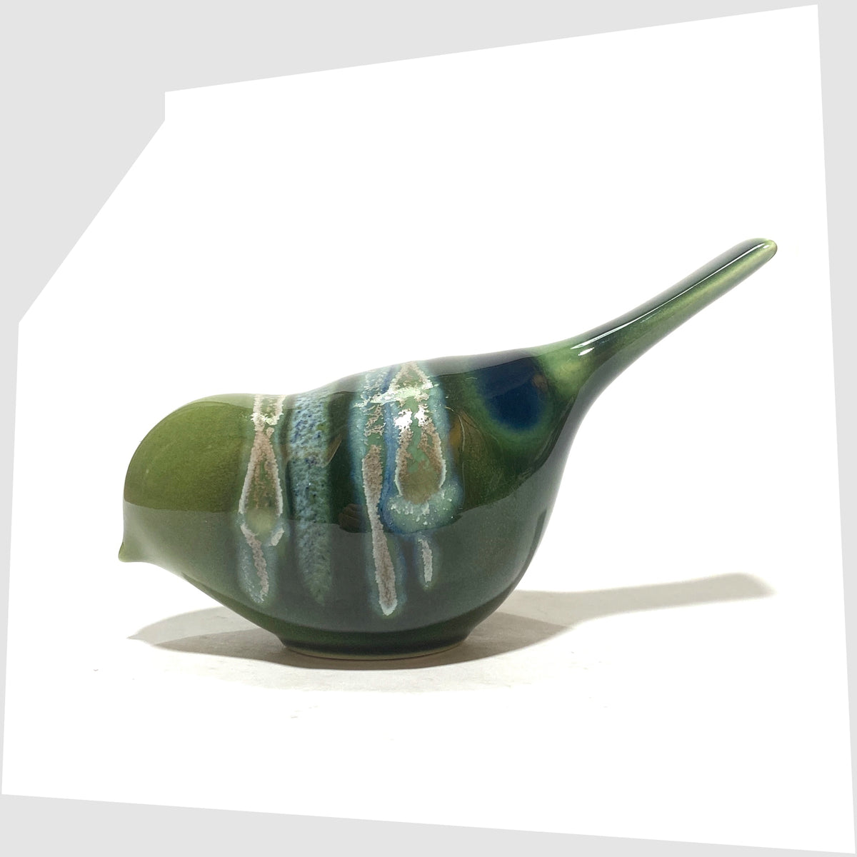 Poole Pottery Pecking Bird Figurine in Maya glaze of green, blue and grey, shown on a white background