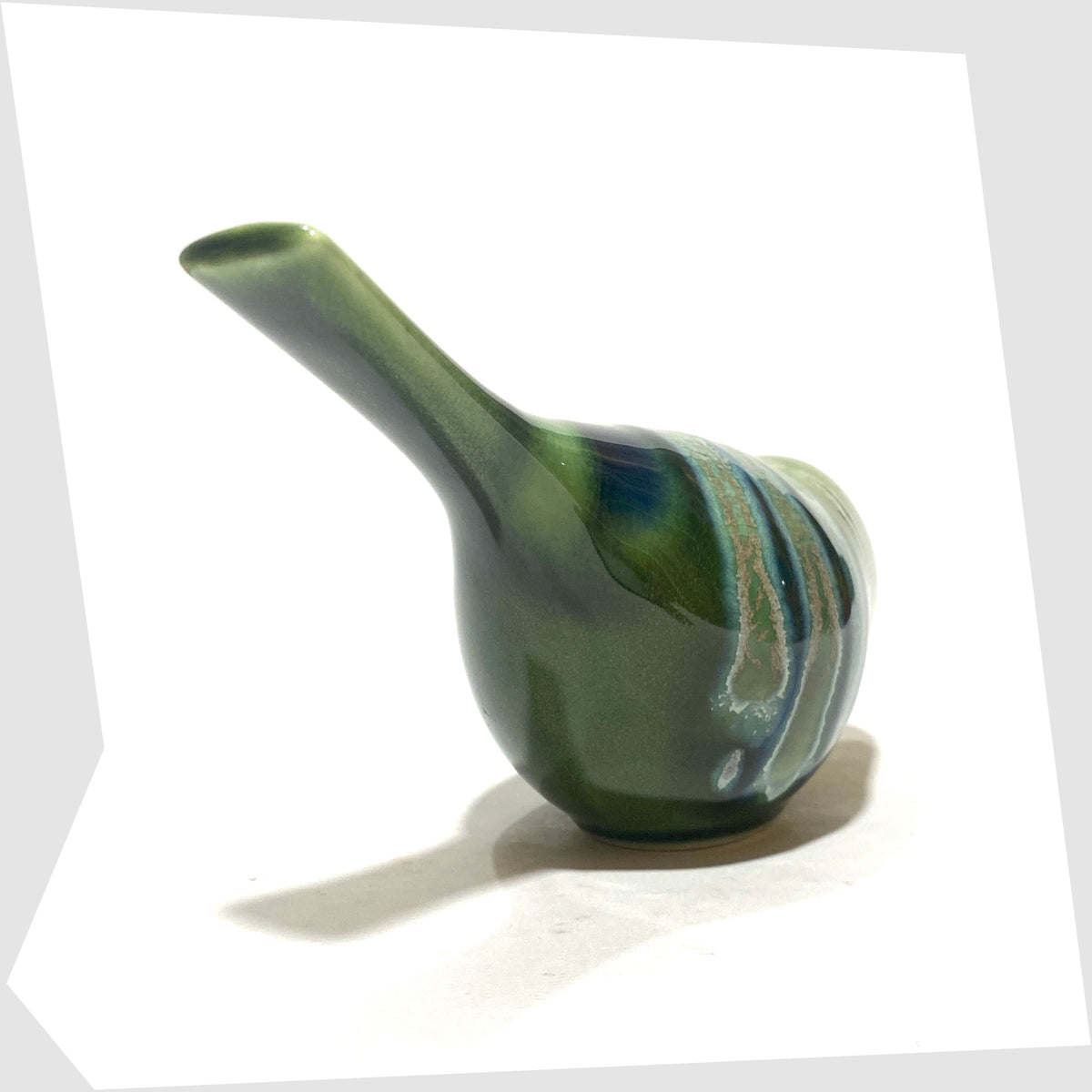 Tail of the Poole Pottery Pecking Bird Figurine in Maya glaze of green, blue and grey, shown on a white background
