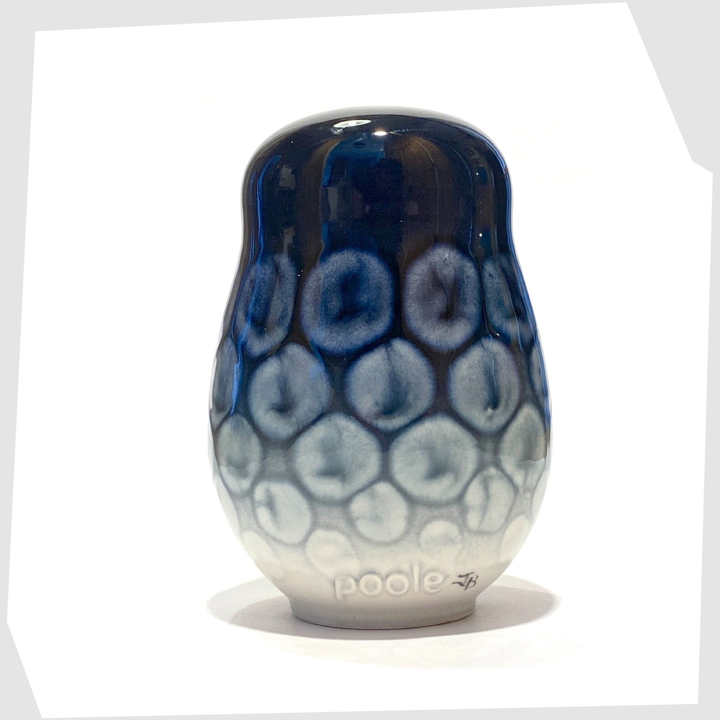 rear of the poole pottery owl ornament in ocean glaze of navy blue with white circular forms