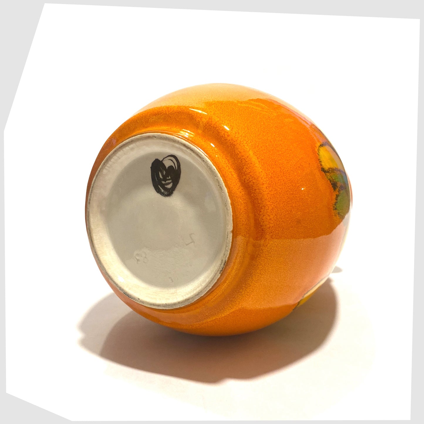 base of the Poole Pottery Delphis Vase by Cynthia Bennett finished in a vivid orange glaze with flowing free-forms of yellow and green