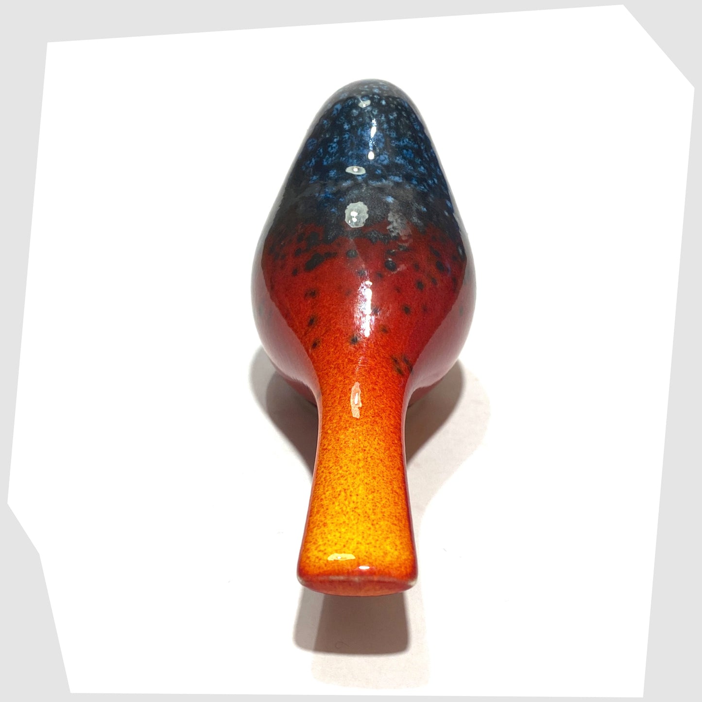 glazing detail of the Poole Pottery Perching Bird in Flare glaze, designed by Alan Clarke, in rich red with black and blue speckles